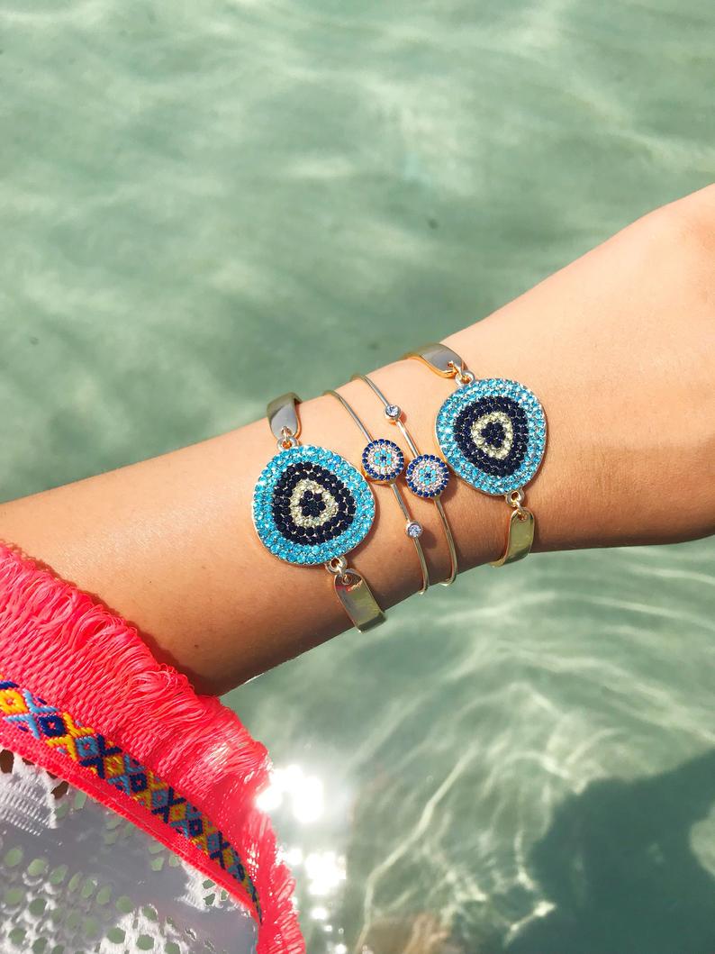 A beautiful Gold Evil Eye Bracelet Set featuring handmade zirconia and bangle designs, symbolizing protection and style.