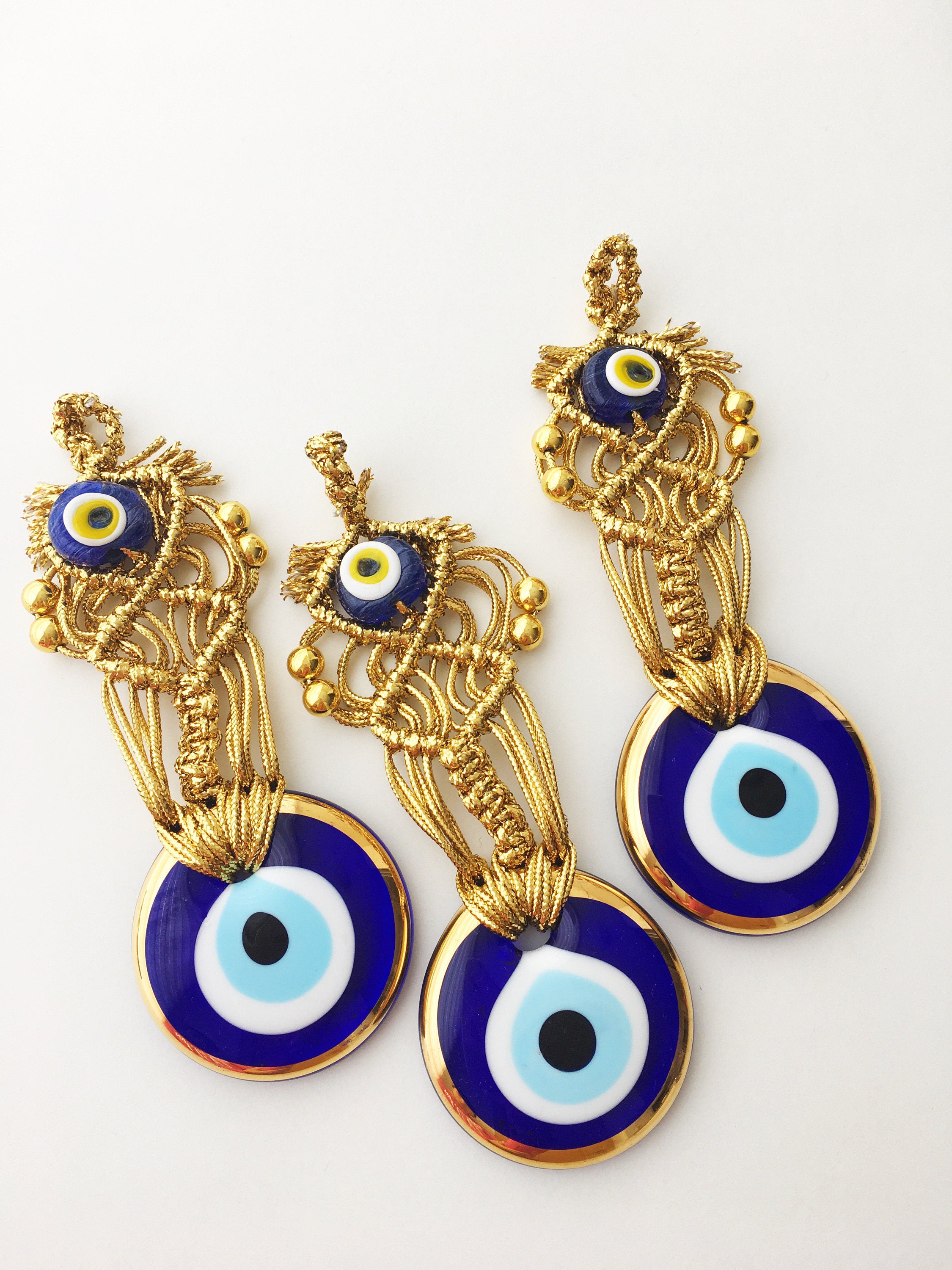 Gold Evil Eye Christmas Tree Ornament featuring a 5.5cm diameter evil eye bead and gold macrame design, perfect for holiday decor.