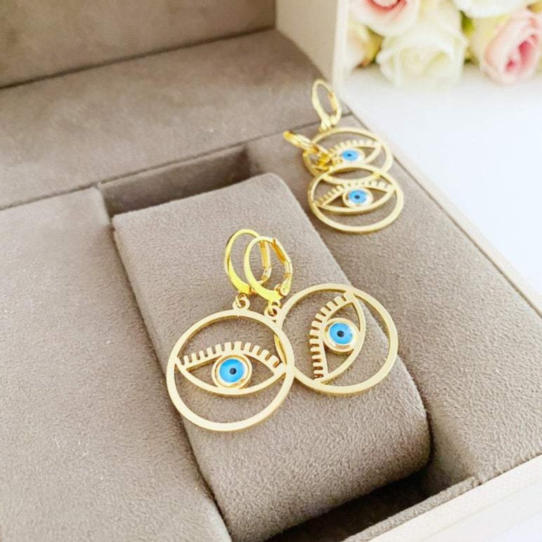 A pair of handmade gold hoop earrings featuring a Greek evil eye bead, symbolizing protection and good luck, measuring 25mm in diameter.