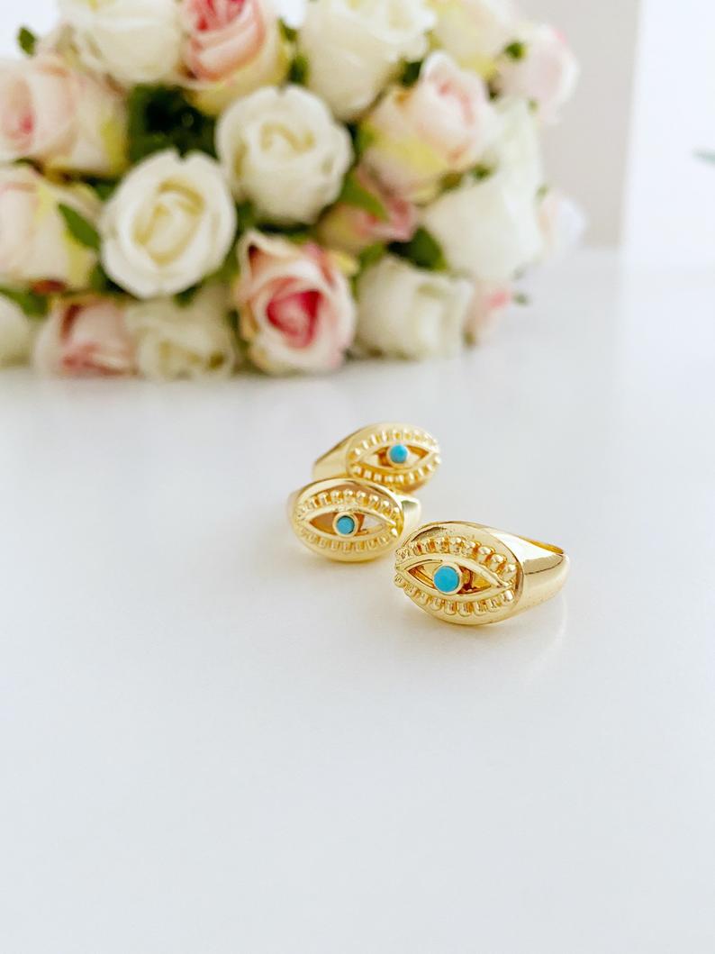 Gold Evil Eye Ring featuring a turquoise bead and adjustable band, symbolizing protection and style.