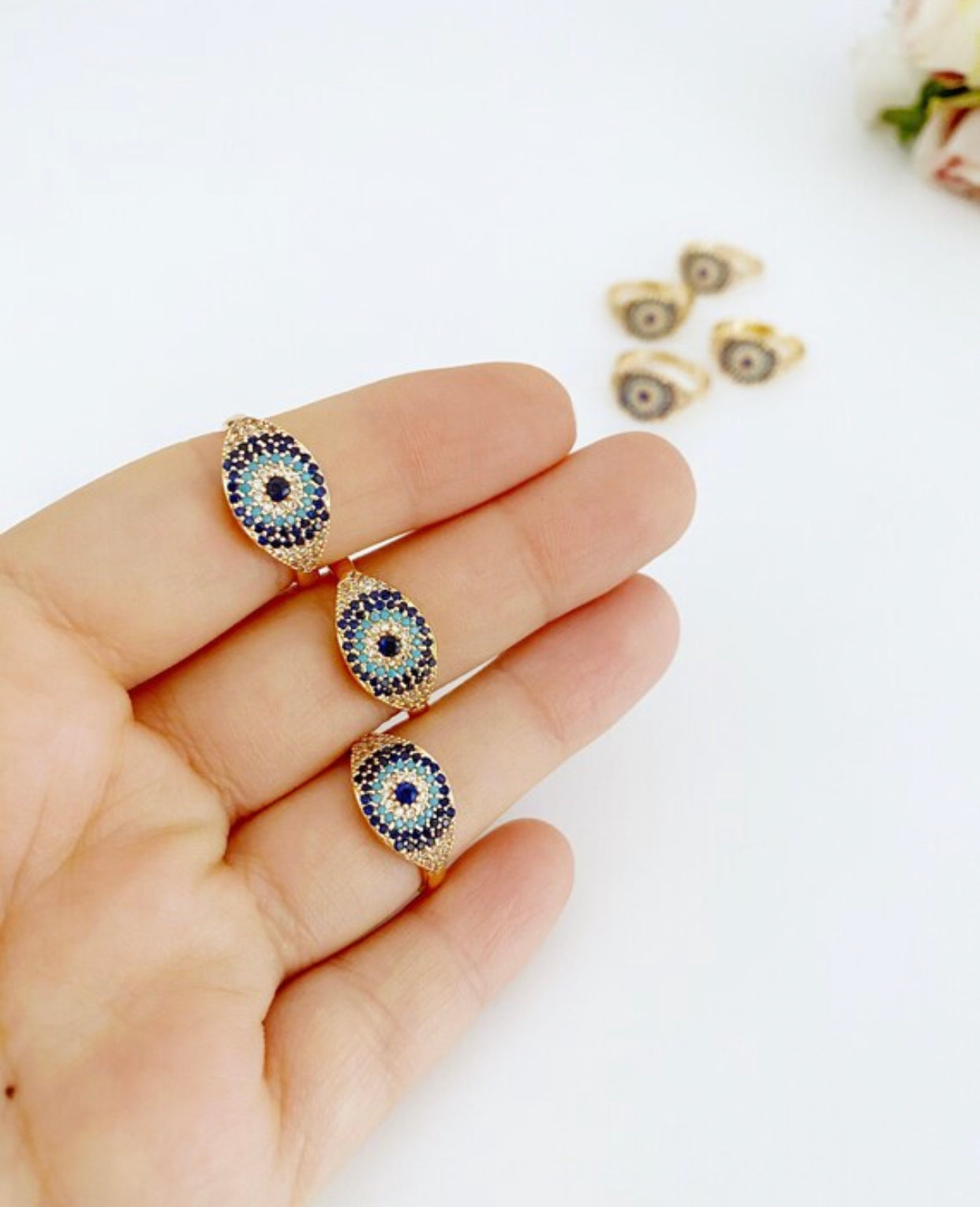 A beautiful gold evil eye ring featuring sparkling zirconia beads, adjustable design for a perfect fit.