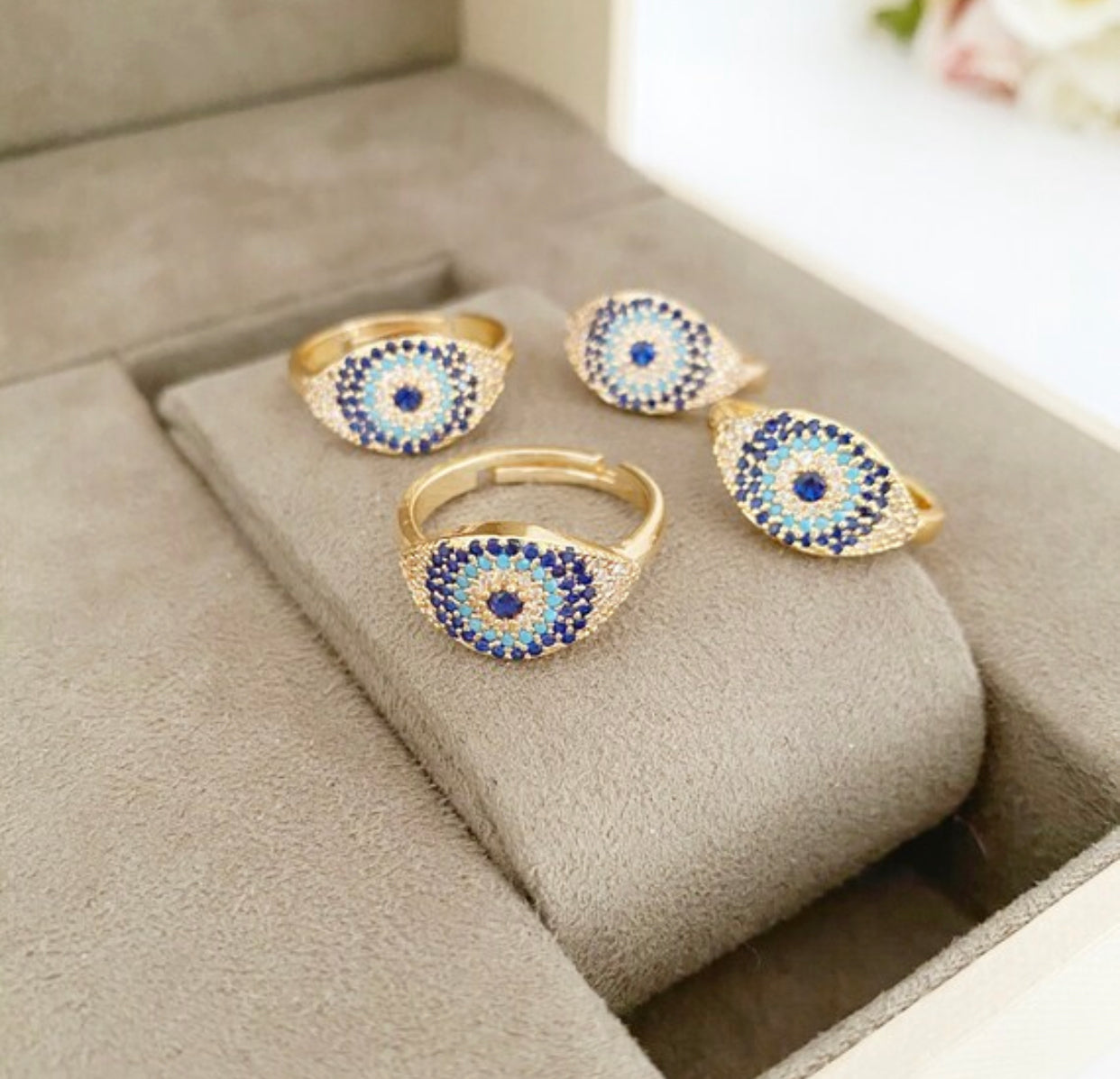 A beautiful gold evil eye ring featuring sparkling zirconia beads, adjustable design for a perfect fit.