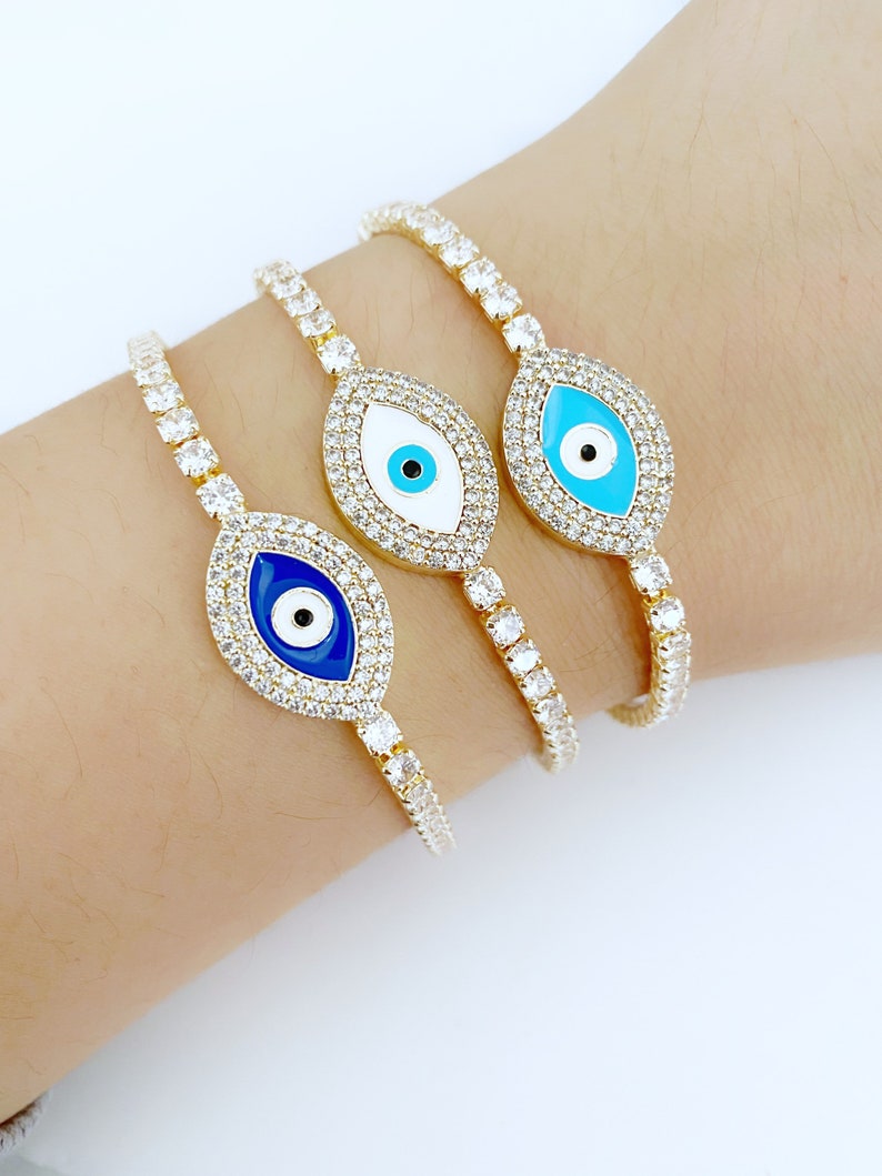 Gold Evil Eye Tennis Bracelet featuring a blue evil eye design, adjustable stainless steel material, and elegant gold finish.