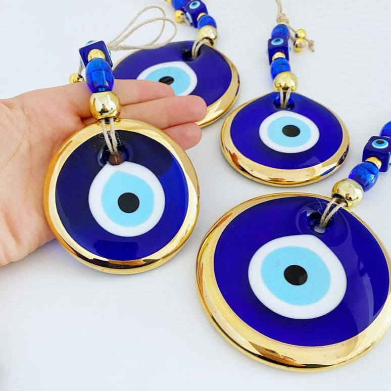 Gold Evil Eye Wall Hanging featuring a large evil eye bead, handmade with intricate details, perfect for home decor and Christmas tree decoration.