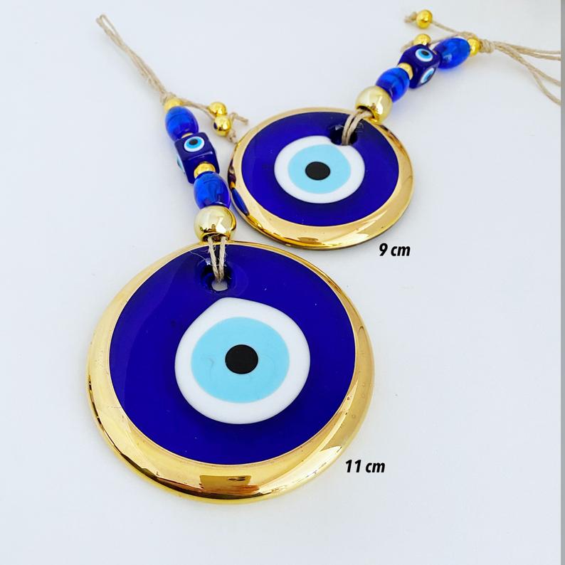 Gold Evil Eye Wall Hanging featuring a large evil eye bead, handmade with intricate details, perfect for home decor and Christmas tree decoration.