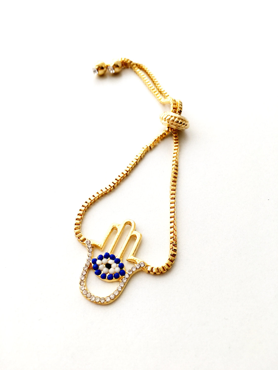 Gold Hamsa Evil Eye Bracelet featuring blue evil eye beads and adjustable stainless steel design.