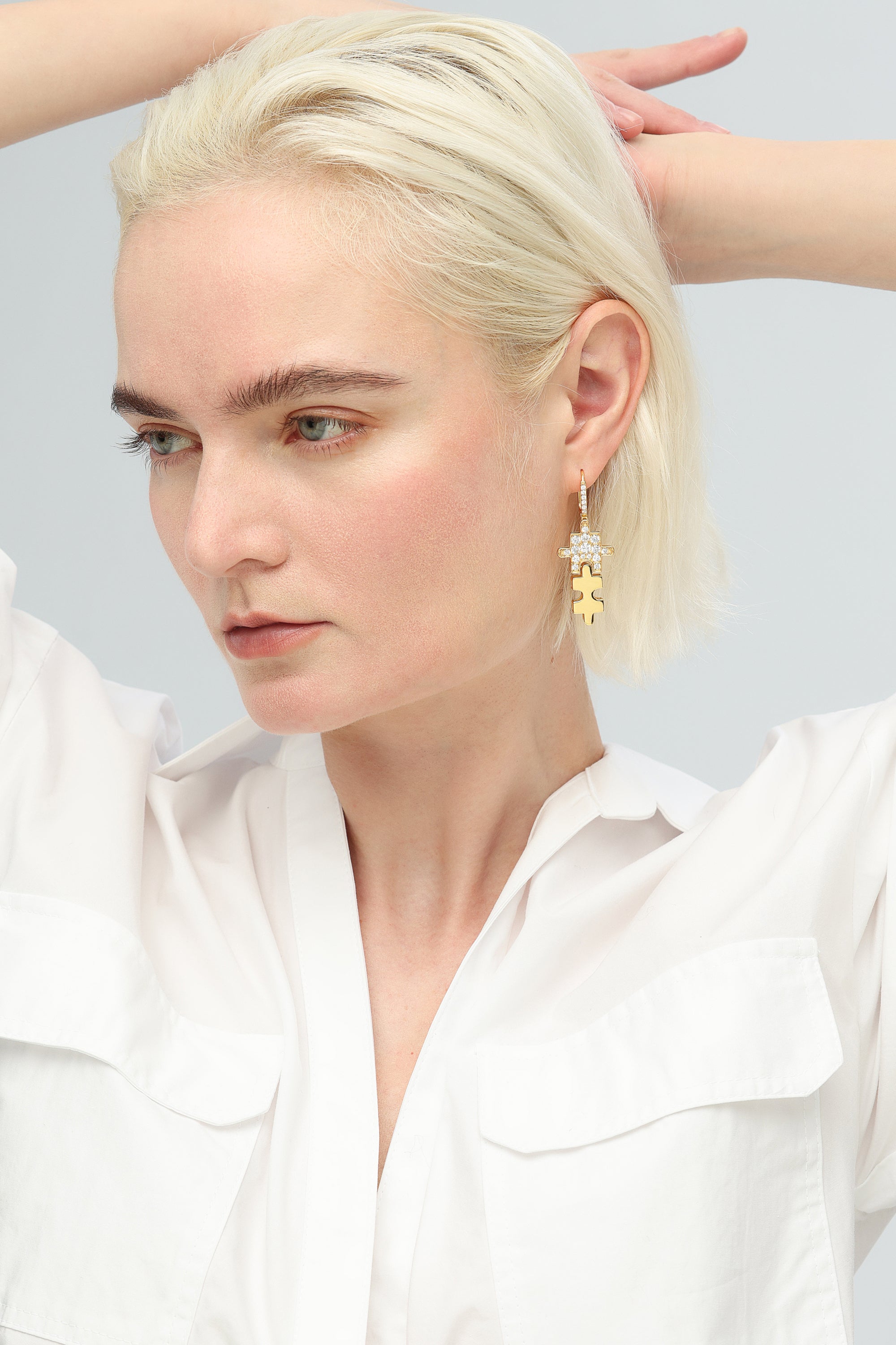 Gold Jigsaw Puzzle Drop Earrings featuring sparkling cubic zirconia stones and huggie hoop design, handcrafted with 18k gold plating.