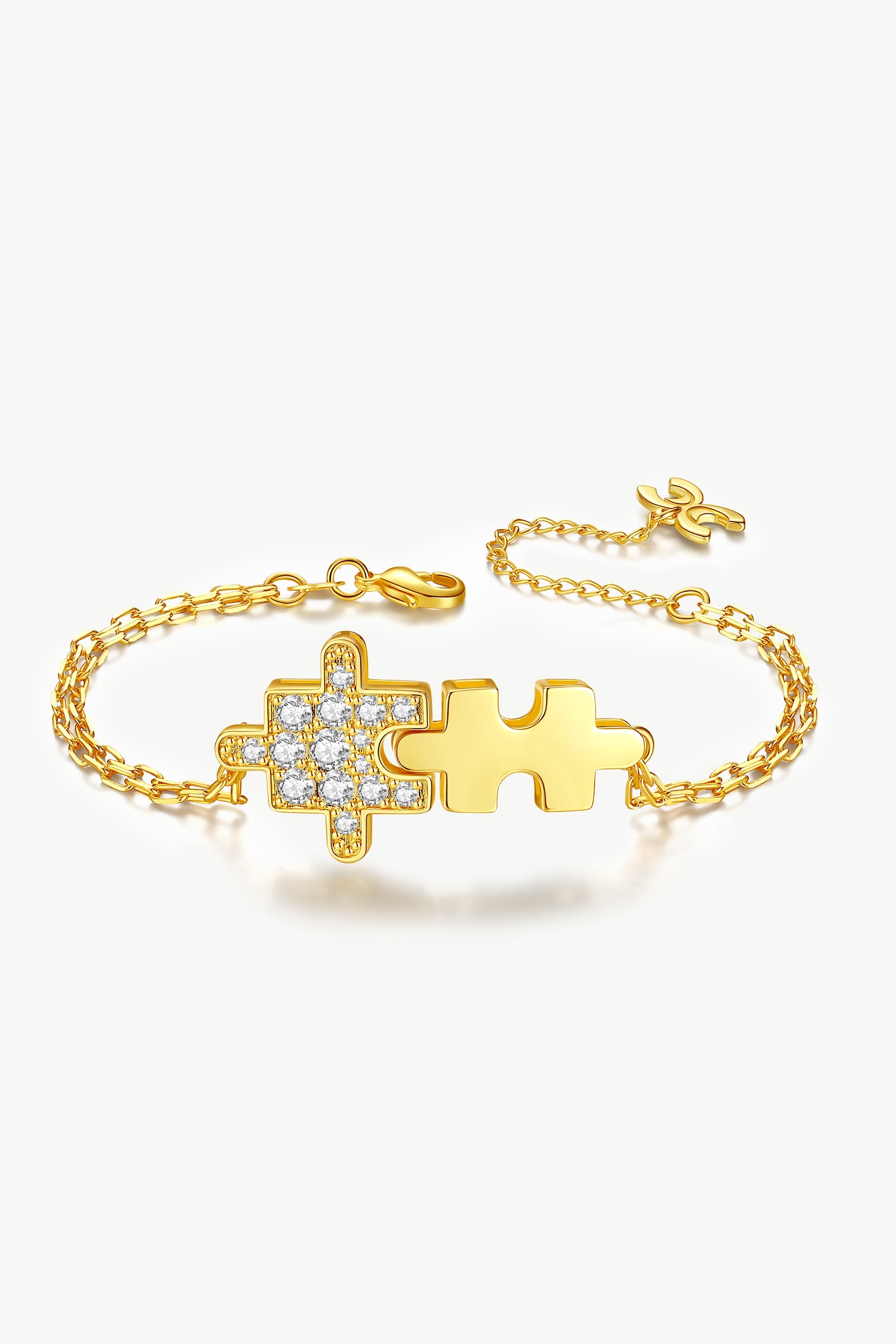 Gold jigsaw puzzle bracelet adorned with sparkling cubic zirconia stones, showcasing a playful design and luxurious 18k gold plating.