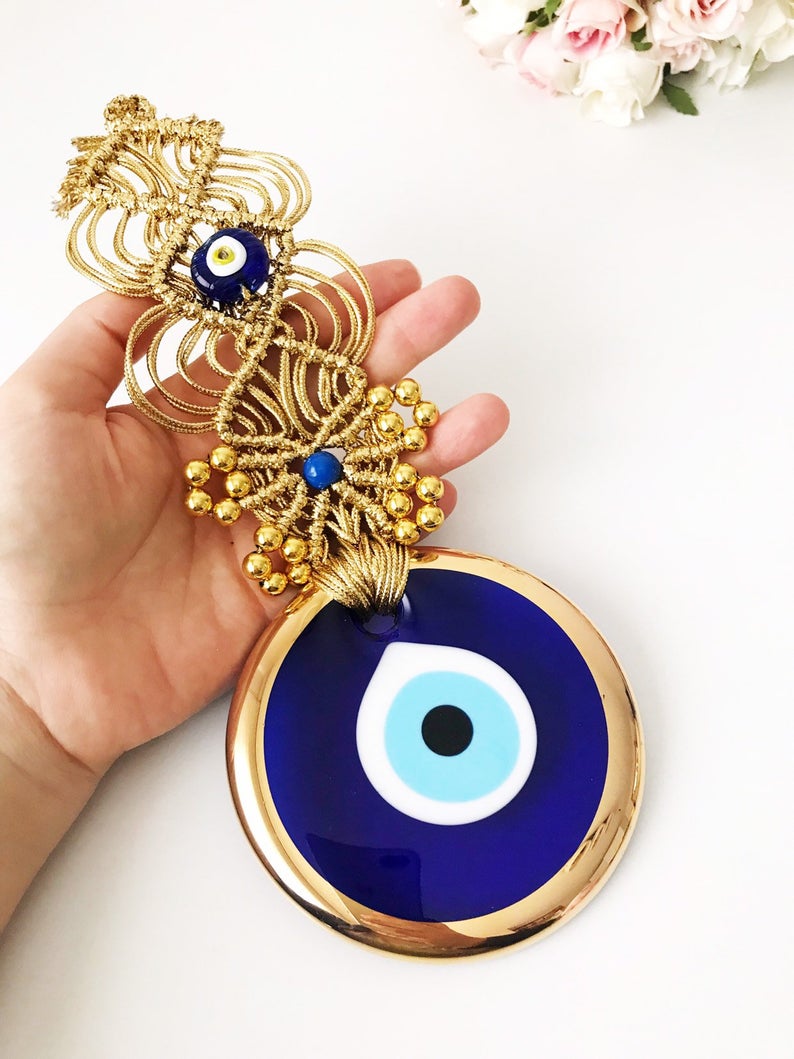 Gold Macrame Evil Eye Wall Decor featuring a 10 cm bead, elegantly handcrafted with intricate macrame design.