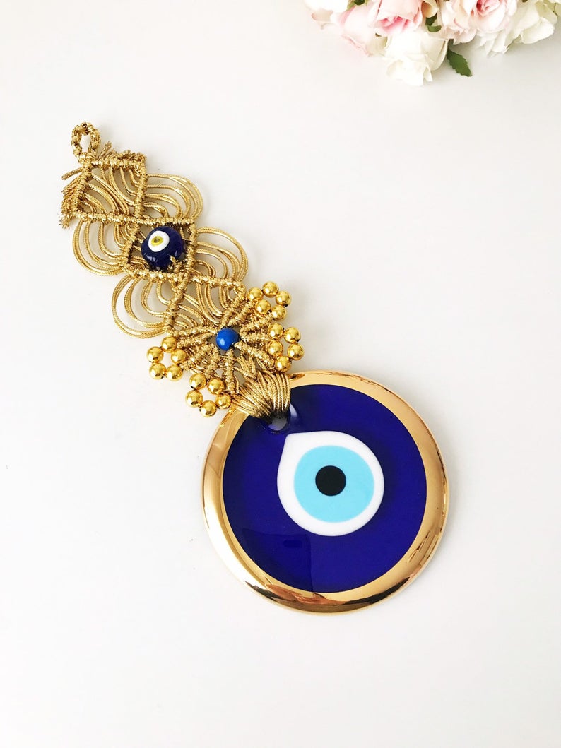 Gold Macrame Evil Eye Wall Decor featuring a 10 cm bead, elegantly handcrafted with intricate macrame design.