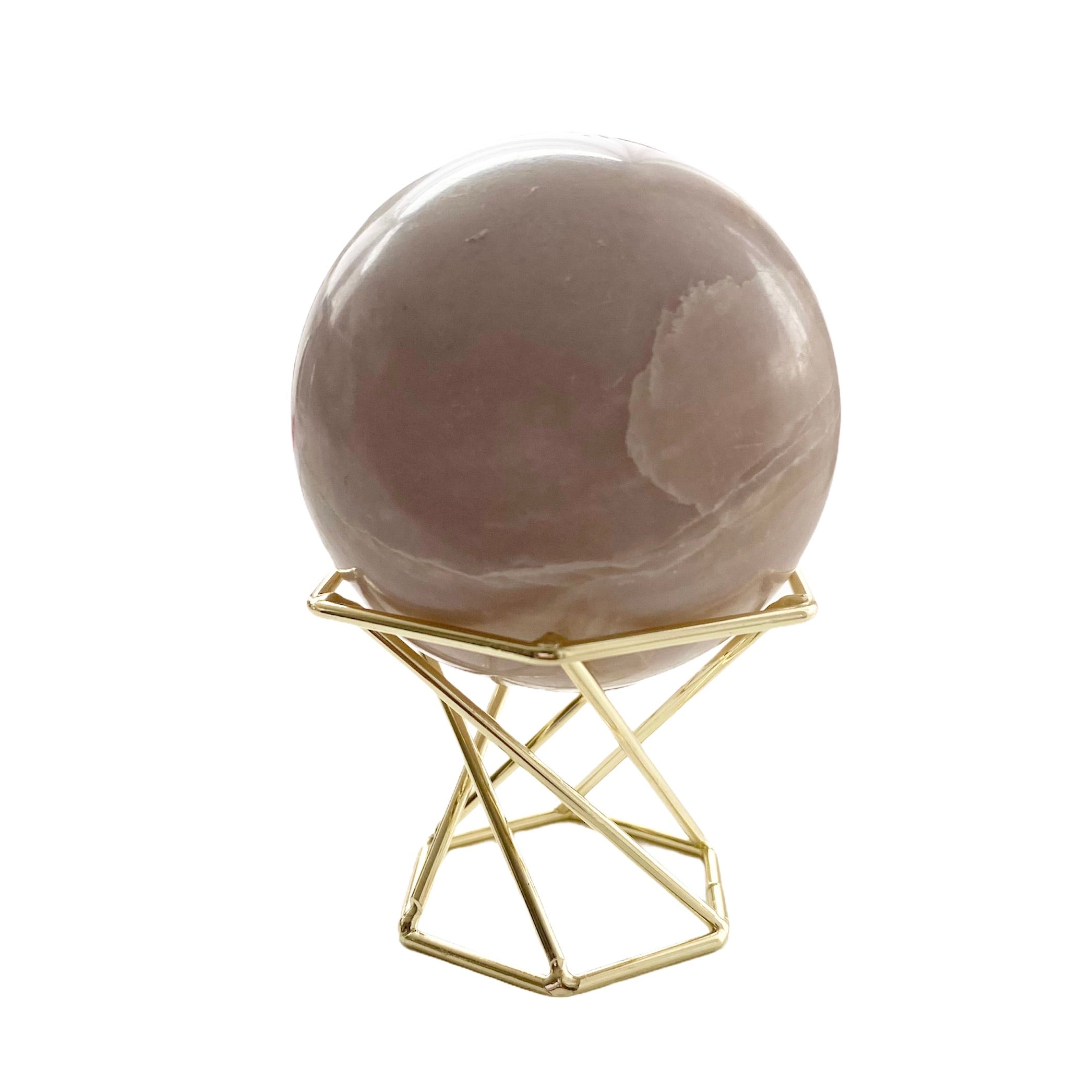 Elegant gold metal crystal stand displaying various sizes of crystals and spheres.