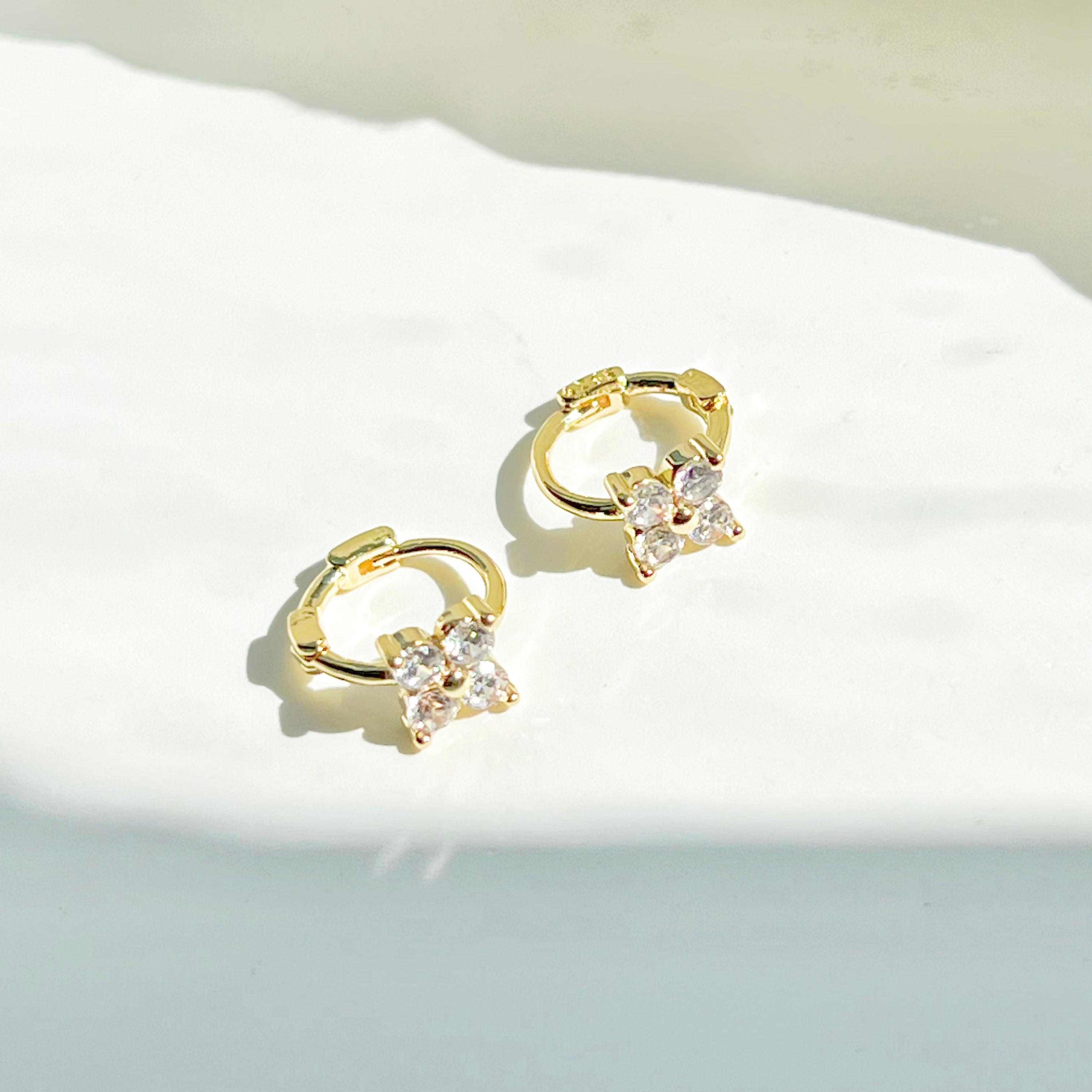 Gold mini hydrangea flower hoop earrings made from sterling silver, featuring a delicate flower design.