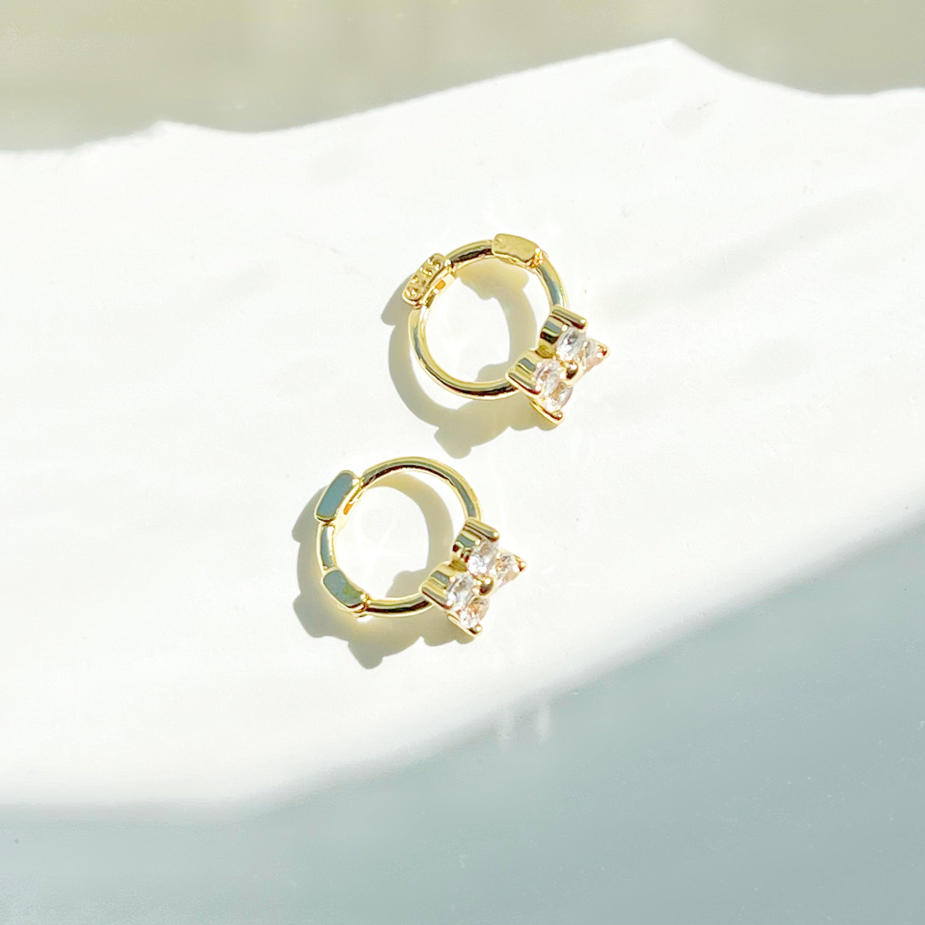 Gold mini hydrangea flower hoop earrings made from sterling silver, featuring a delicate flower design.