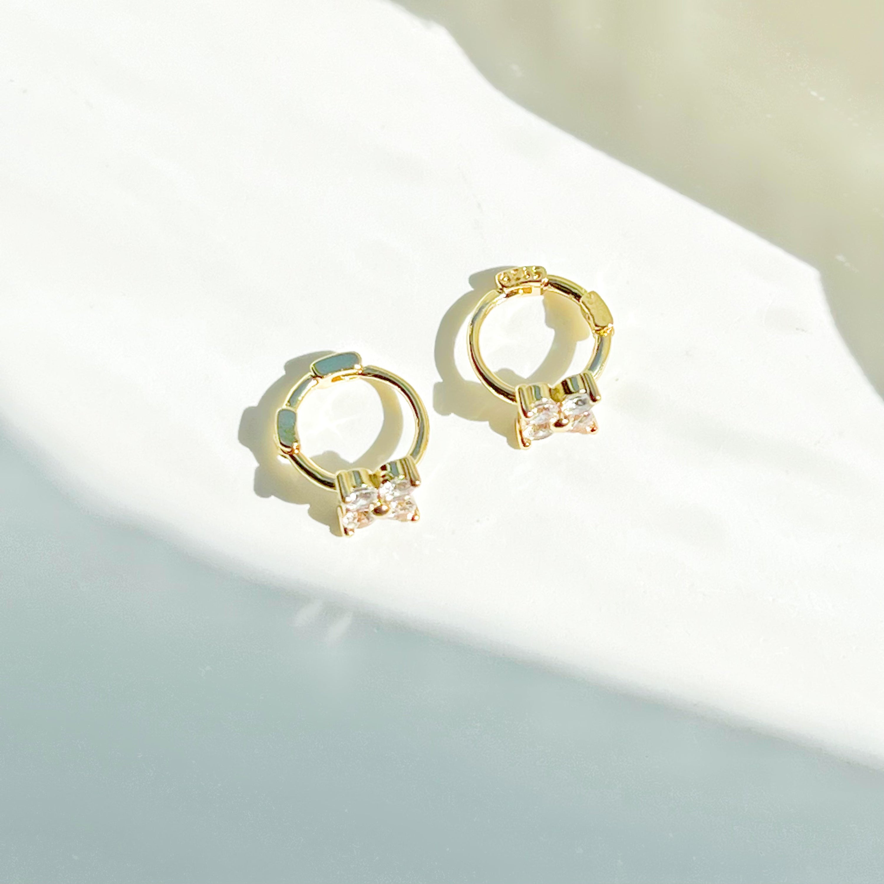 Gold mini hydrangea flower hoop earrings made from sterling silver, featuring a delicate flower design.