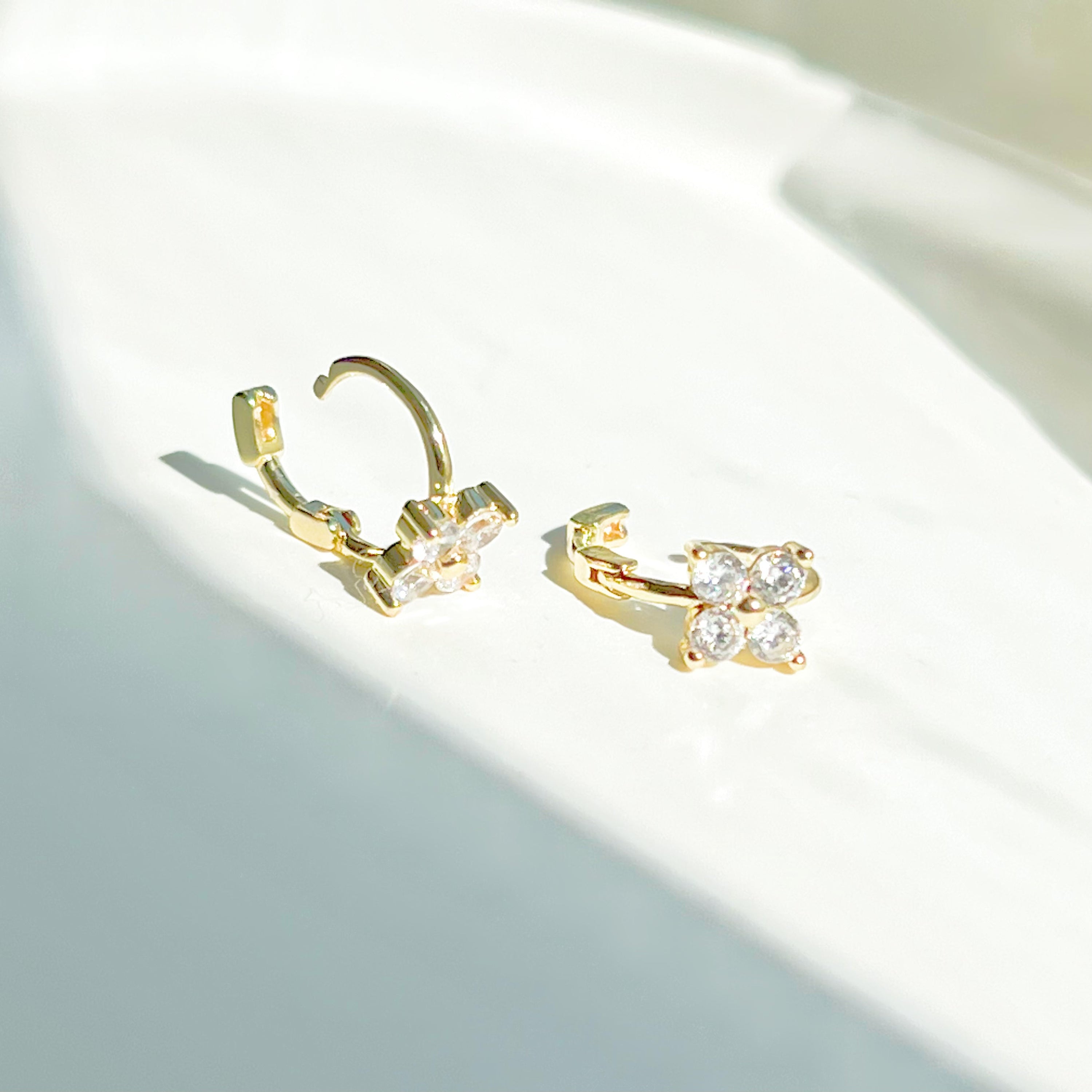 Gold mini hydrangea flower hoop earrings made from sterling silver, featuring a delicate flower design.