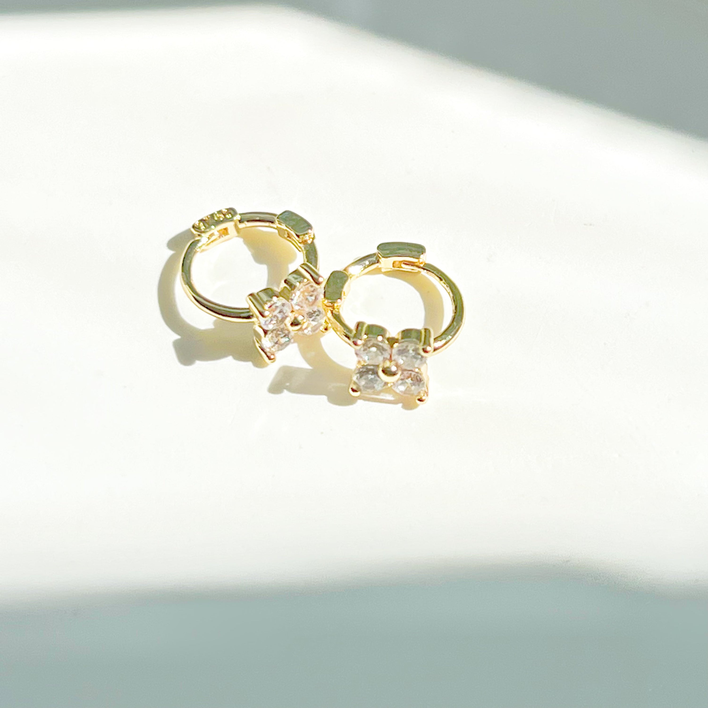 Gold mini hydrangea flower hoop earrings made from sterling silver, featuring a delicate flower design.