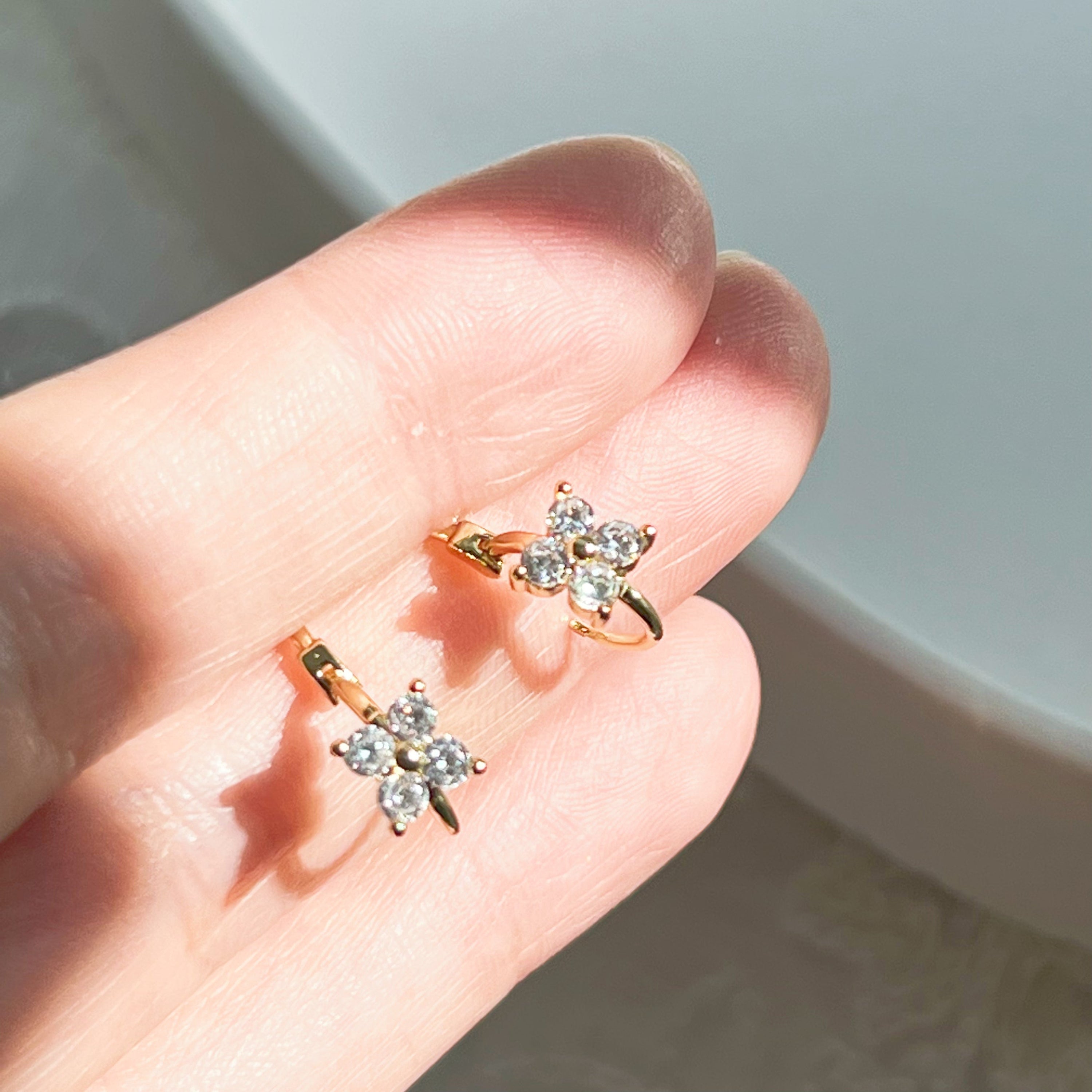 Gold mini hydrangea flower hoop earrings made from sterling silver, featuring a delicate flower design.