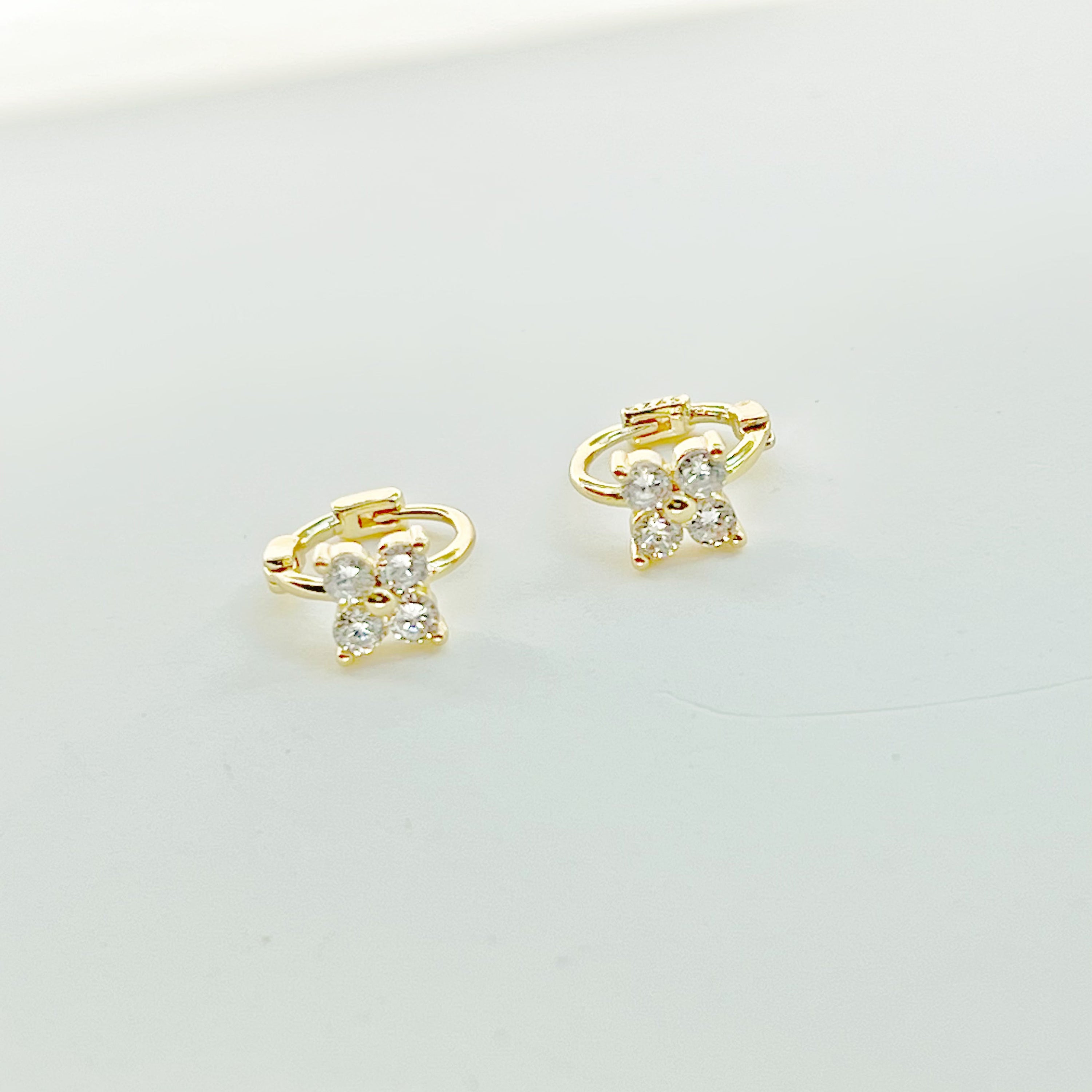 Gold mini hydrangea flower hoop earrings made from sterling silver, featuring a delicate flower design.