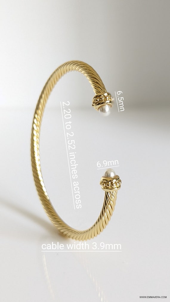 Elegant Gold Pearl Bangle Bracelet with twisted cable design and synthetic pearl accent, showcasing its adjustable fit and stylish appearance.