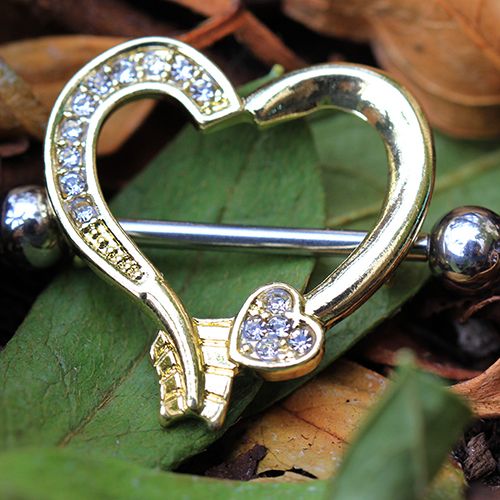 Gold Plated Arrow Heart Nipple Shield with clear CZ stones, showcasing a heart and arrow design.