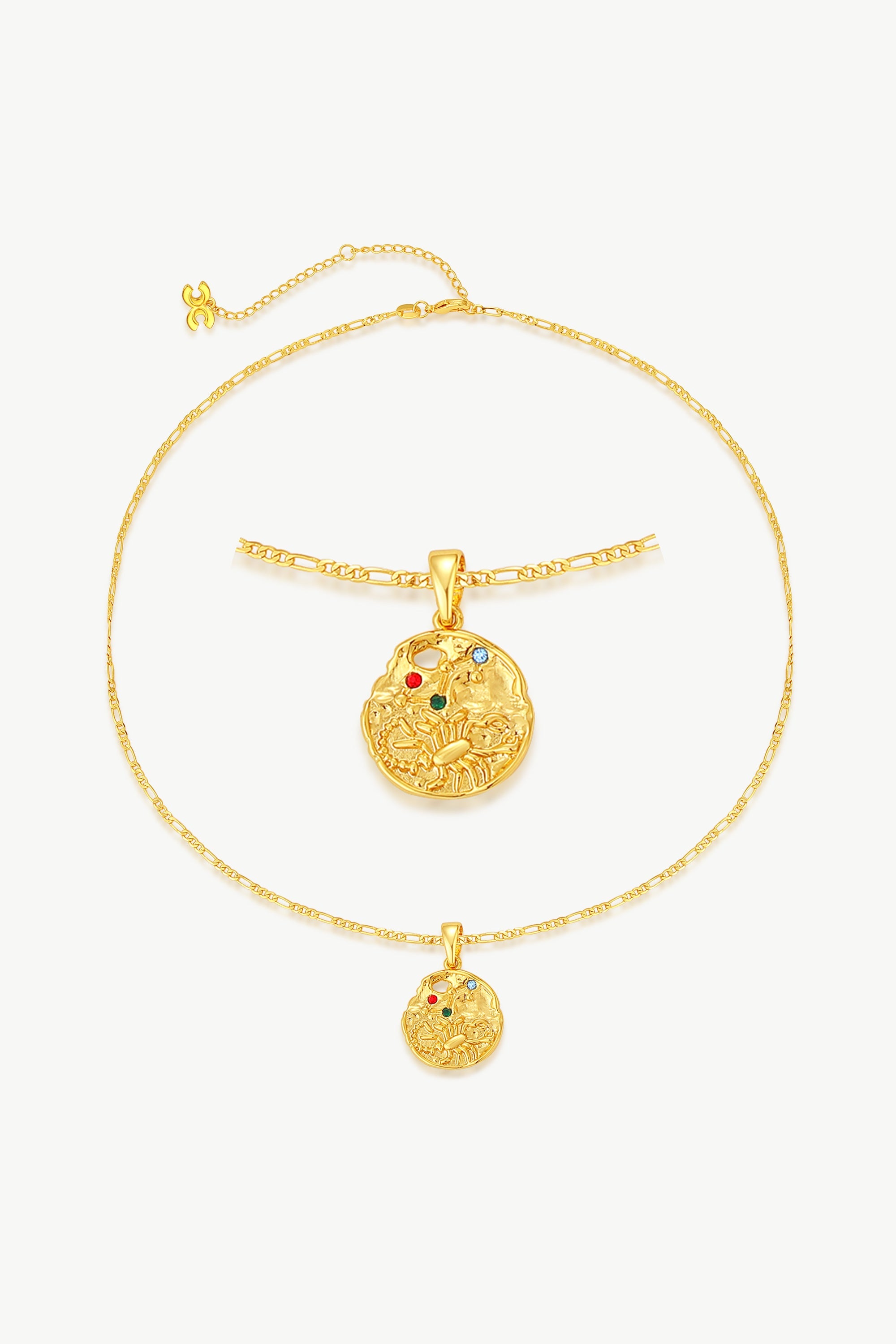 Gold Sculptural Zodiac Sign Pendant Necklace Set featuring an engraved zodiac charm, pearl necklace, and gold figaro chain.