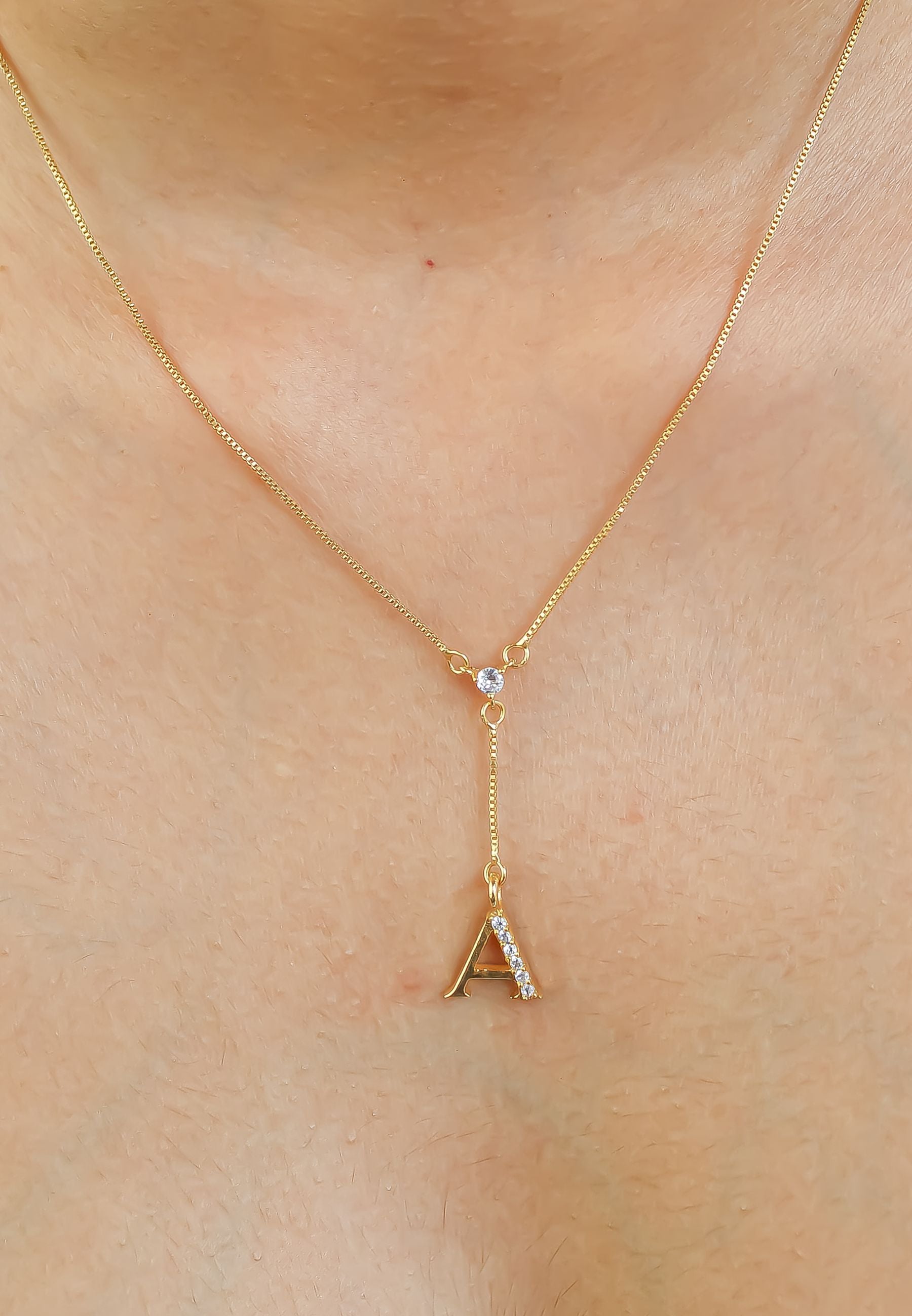 Elegant Golden Alphabet Necklace with zirconia stones, showcasing a personalized initial, perfect for layering or gifting.