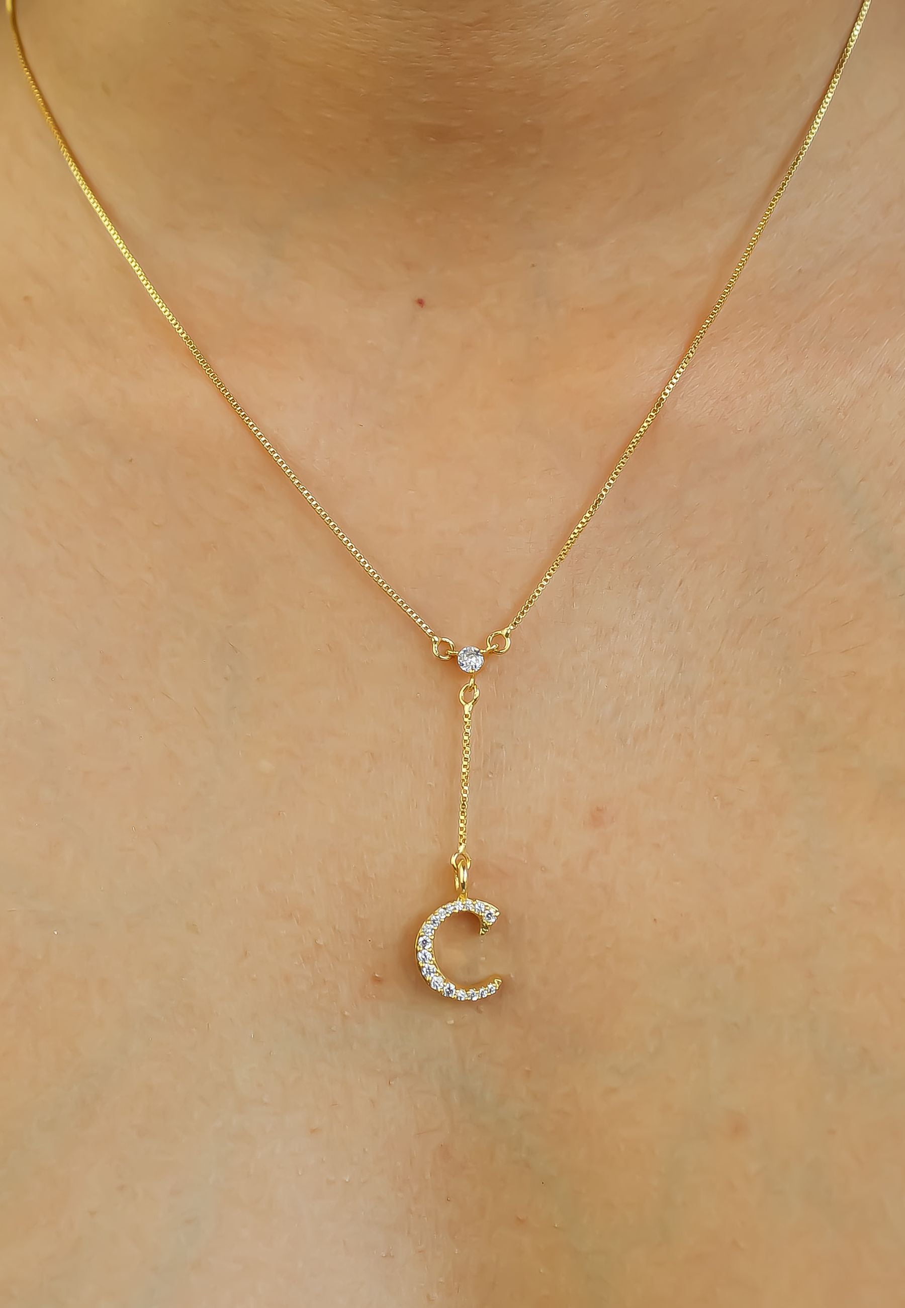 Elegant Golden Alphabet Necklace with zirconia stones, showcasing a personalized initial, perfect for layering or gifting.