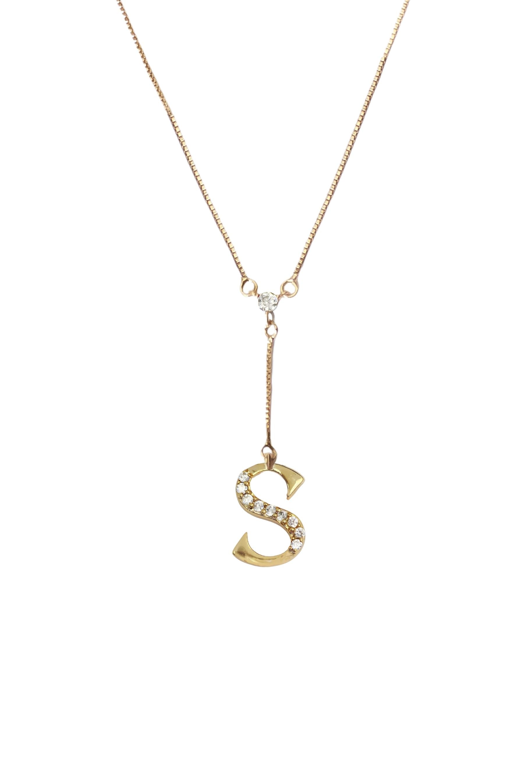 Elegant Golden Alphabet Necklace with zirconia stones, showcasing a personalized initial, perfect for layering or gifting.