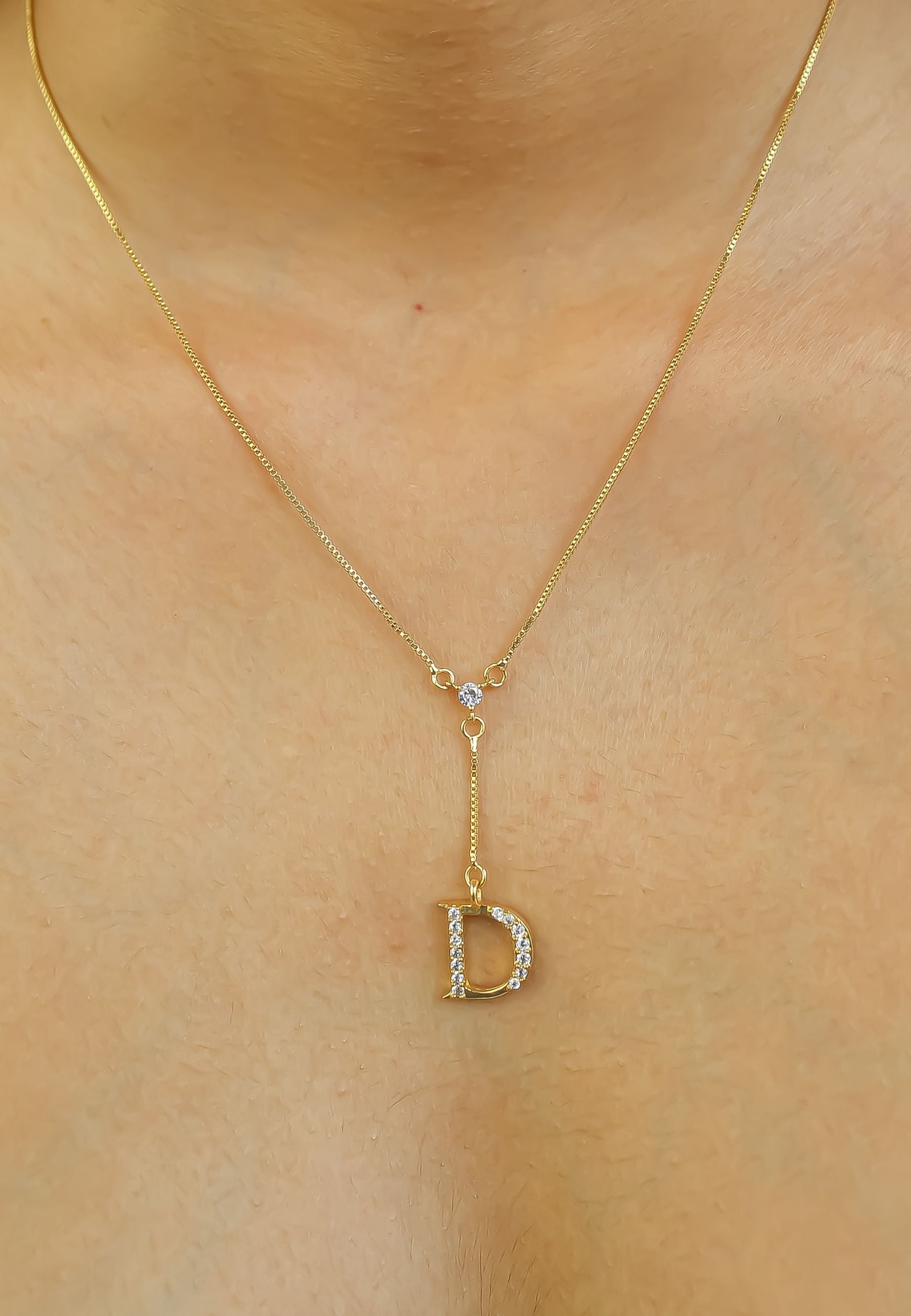 Elegant Golden Alphabet Necklace with zirconia stones, showcasing a personalized initial, perfect for layering or gifting.