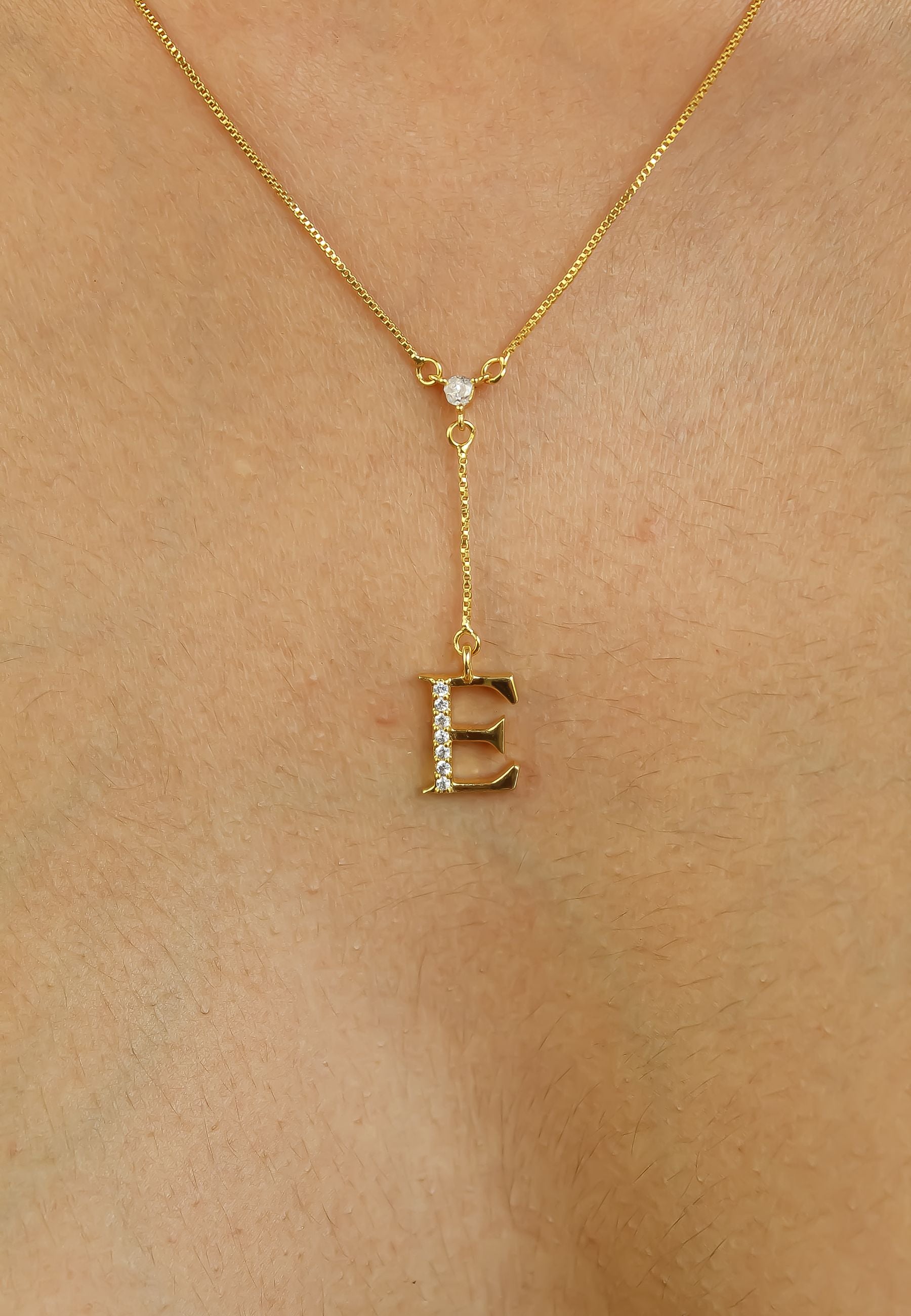 Elegant Golden Alphabet Necklace with zirconia stones, showcasing a personalized initial, perfect for layering or gifting.