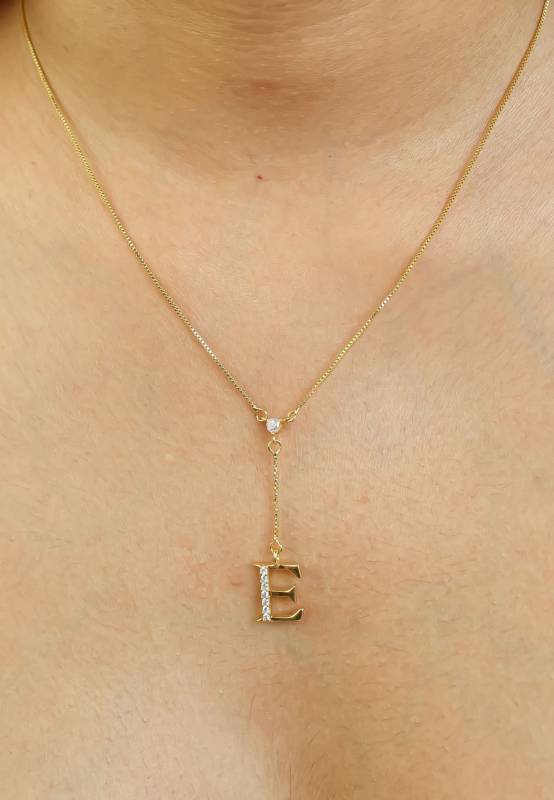 Elegant Golden Alphabet Necklace with zirconia stones, showcasing a personalized initial, perfect for layering or gifting.