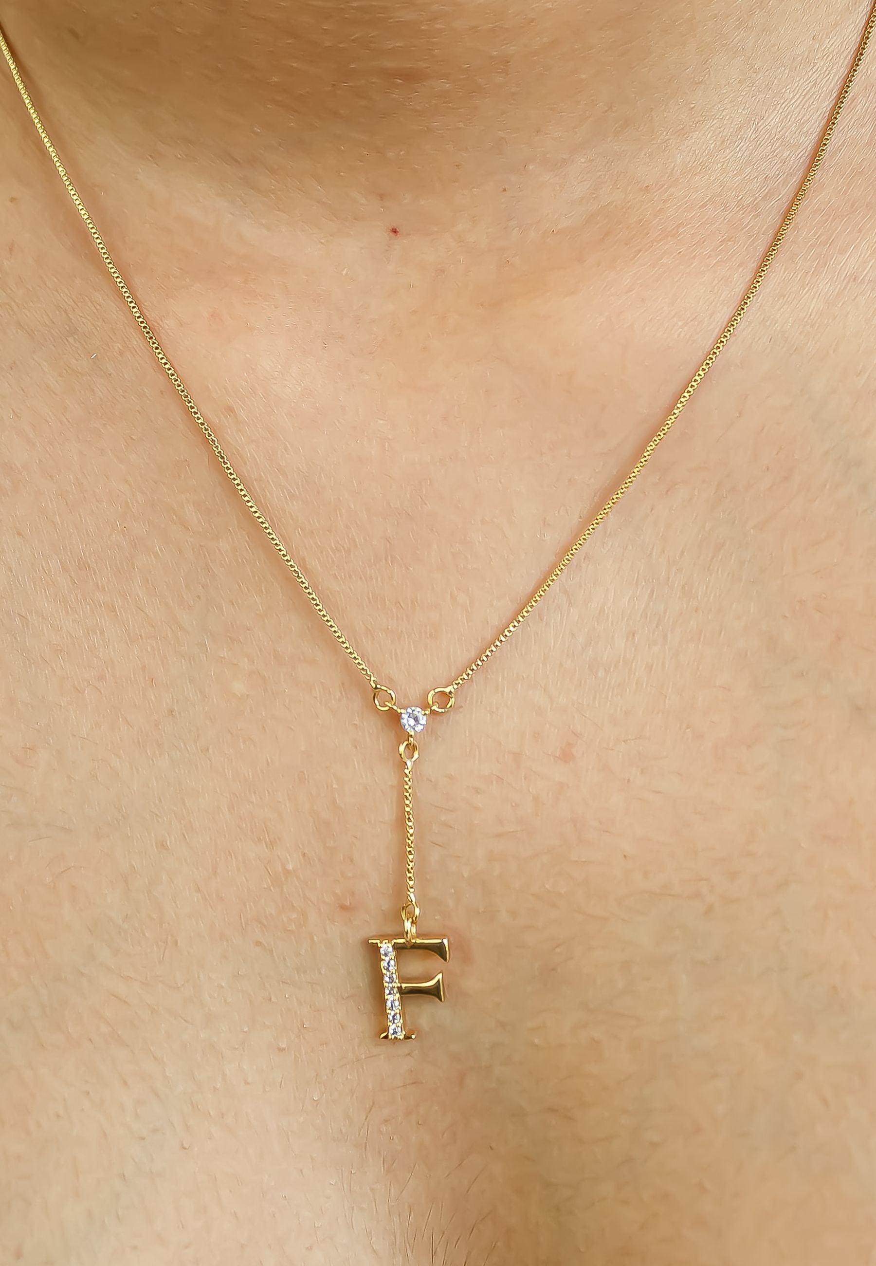 Elegant Golden Alphabet Necklace with zirconia stones, showcasing a personalized initial, perfect for layering or gifting.