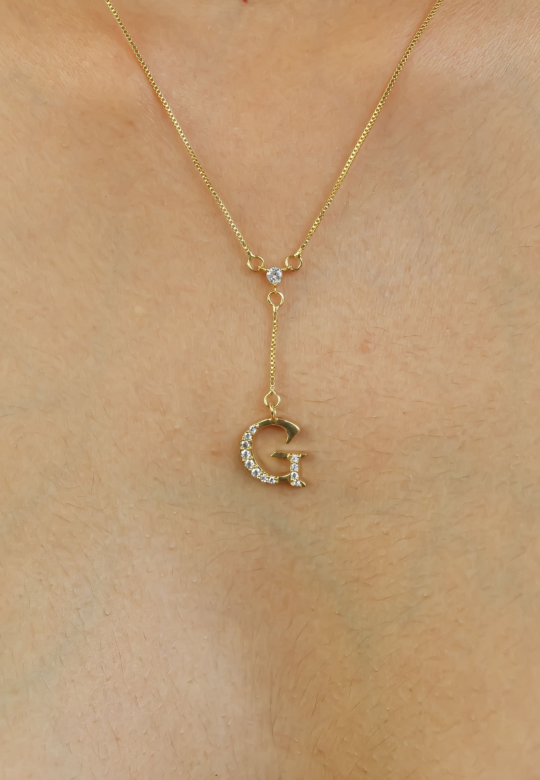 Elegant Golden Alphabet Necklace with zirconia stones, showcasing a personalized initial, perfect for layering or gifting.