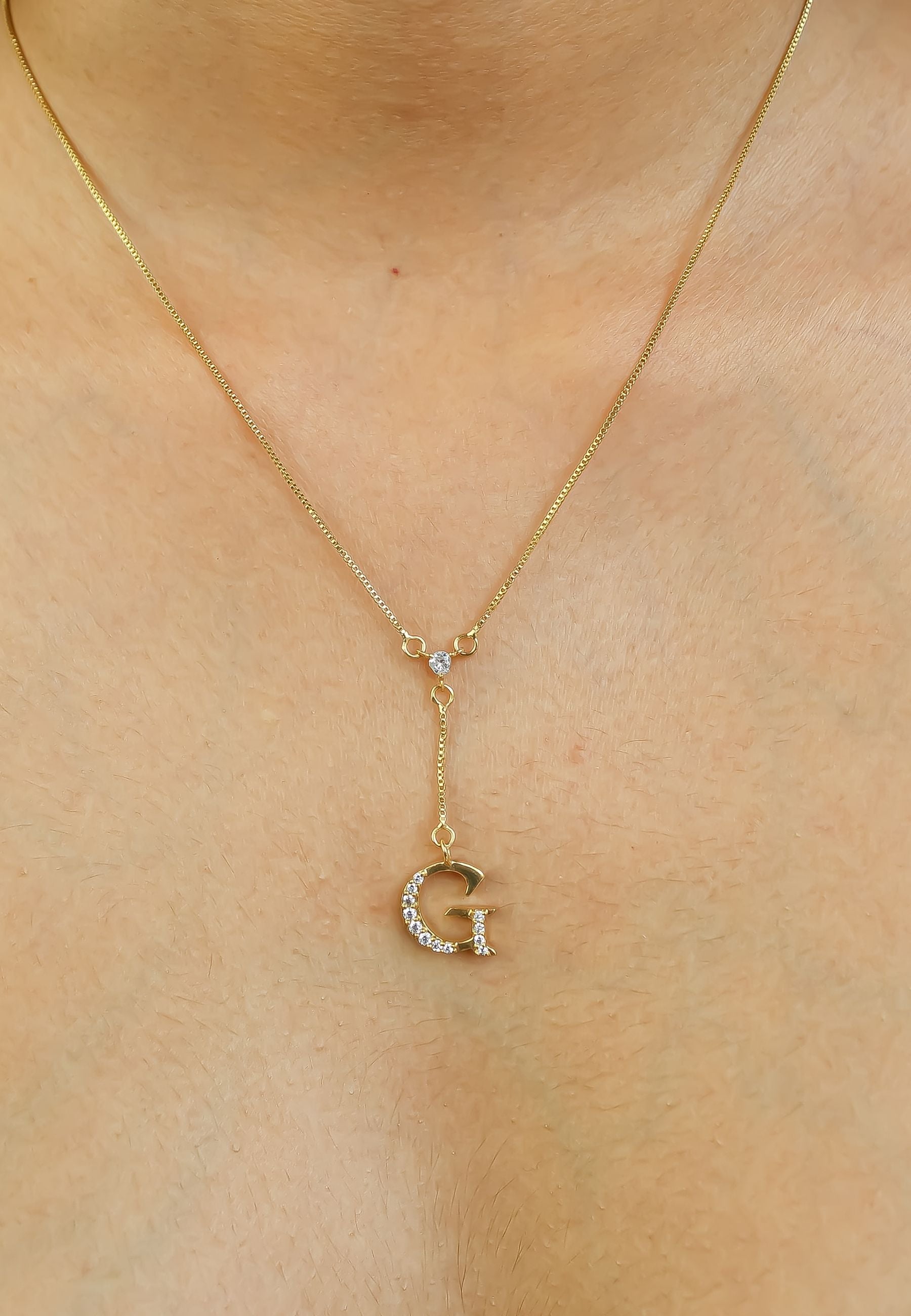 Elegant Golden Alphabet Necklace with zirconia stones, showcasing a personalized initial, perfect for layering or gifting.