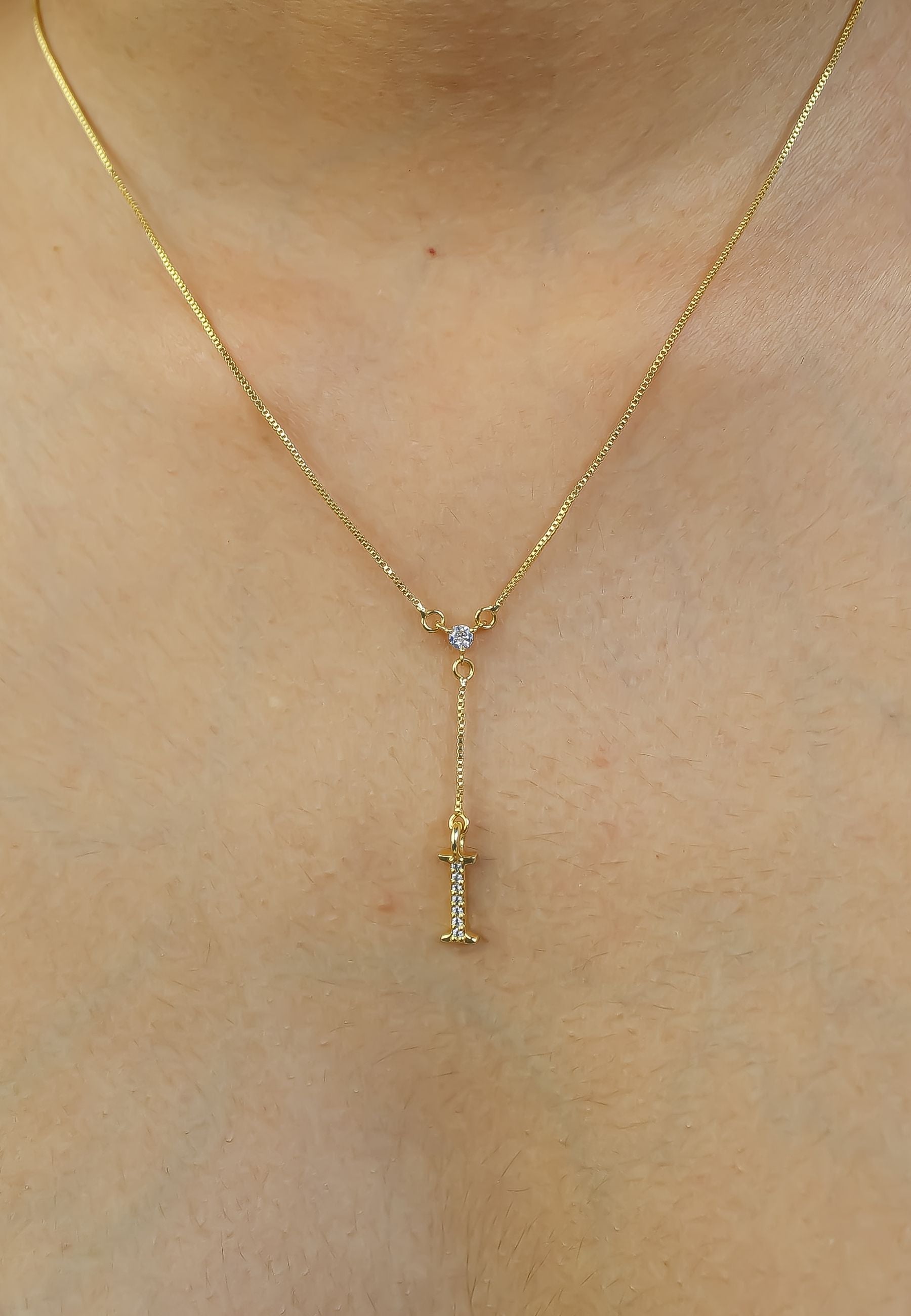 Elegant Golden Alphabet Necklace with zirconia stones, showcasing a personalized initial, perfect for layering or gifting.