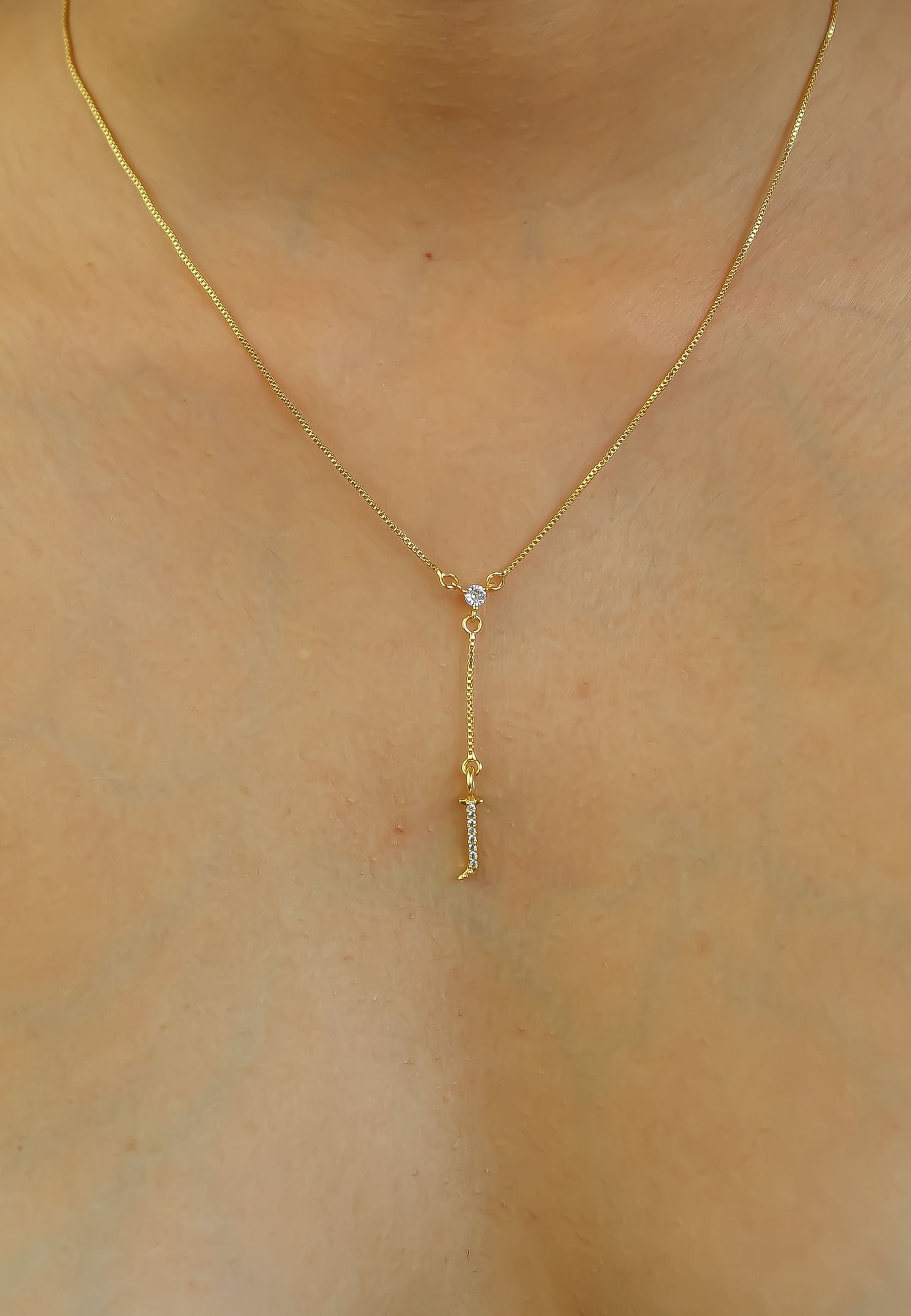 Elegant Golden Alphabet Necklace with zirconia stones, showcasing a personalized initial, perfect for layering or gifting.