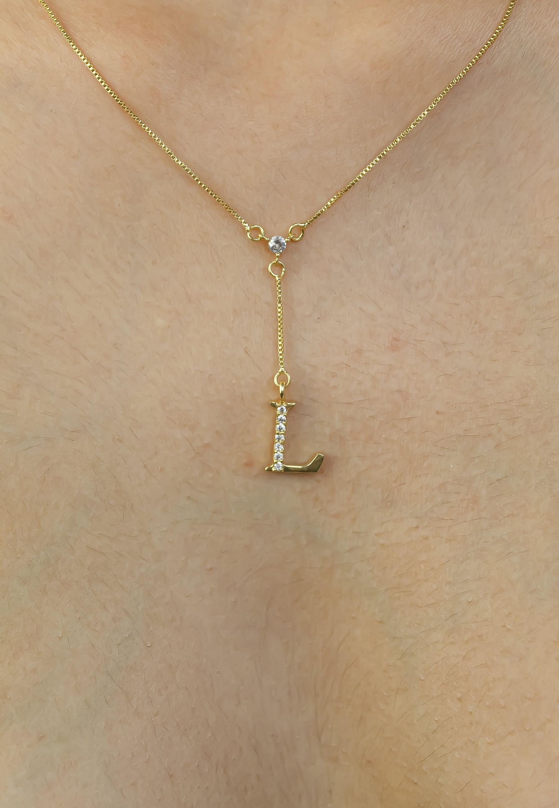 Elegant Golden Alphabet Necklace with zirconia stones, showcasing a personalized initial, perfect for layering or gifting.