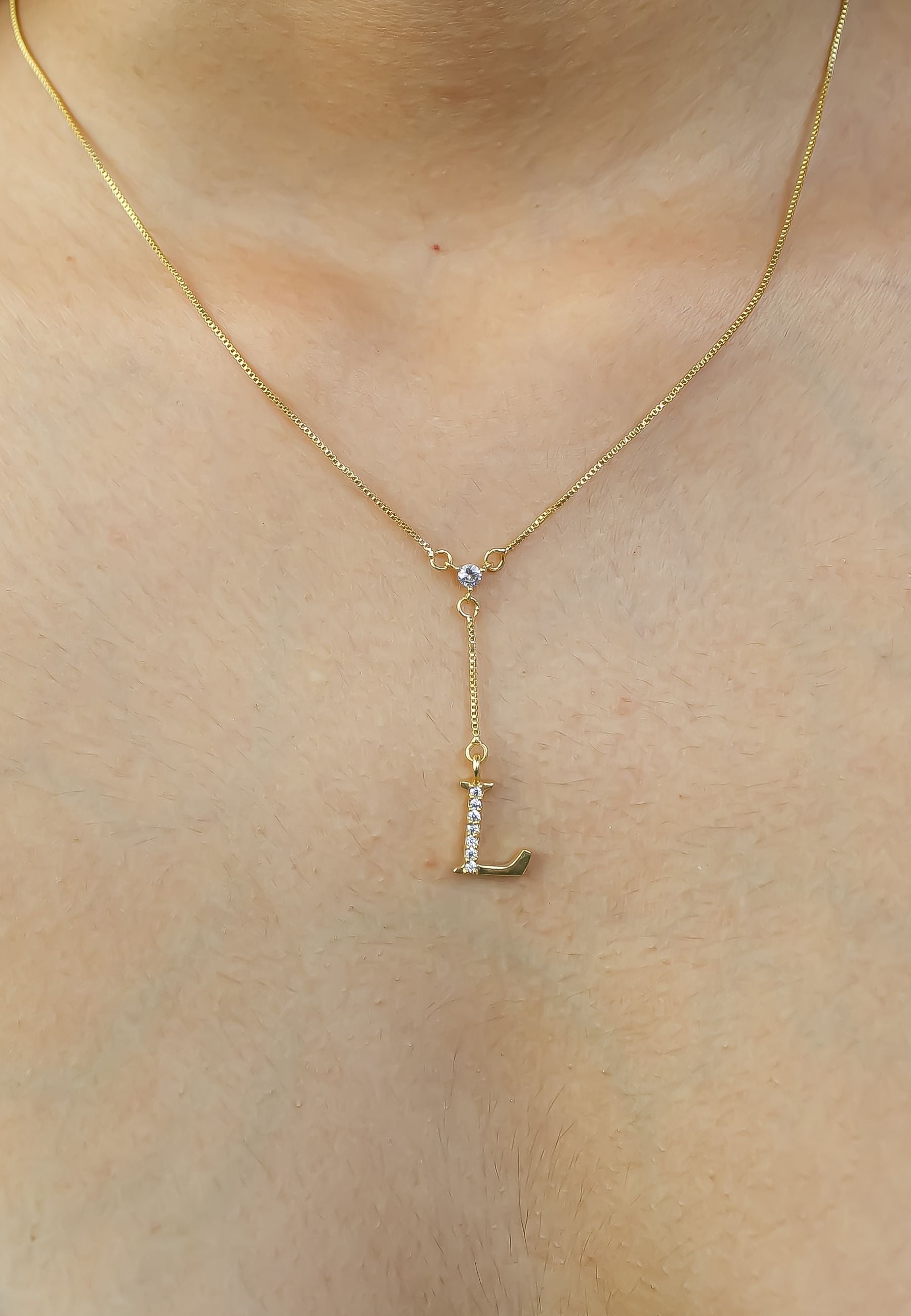 Elegant Golden Alphabet Necklace with zirconia stones, showcasing a personalized initial, perfect for layering or gifting.