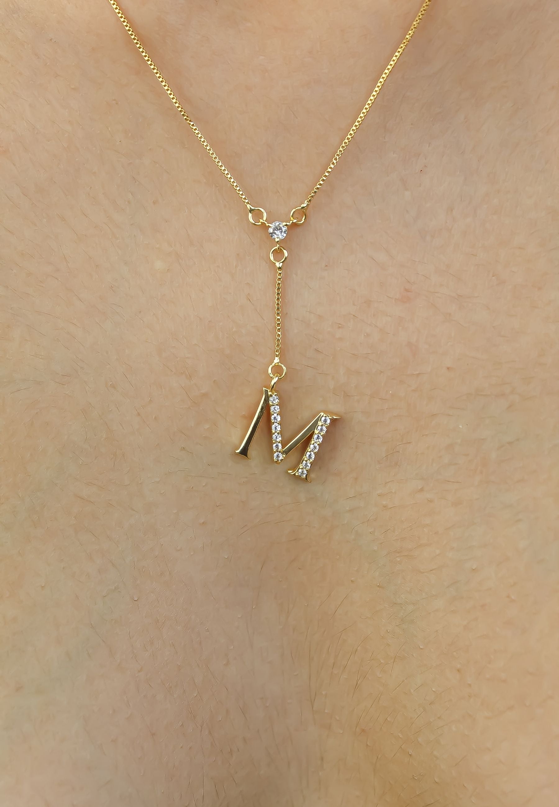 Elegant Golden Alphabet Necklace with zirconia stones, showcasing a personalized initial, perfect for layering or gifting.