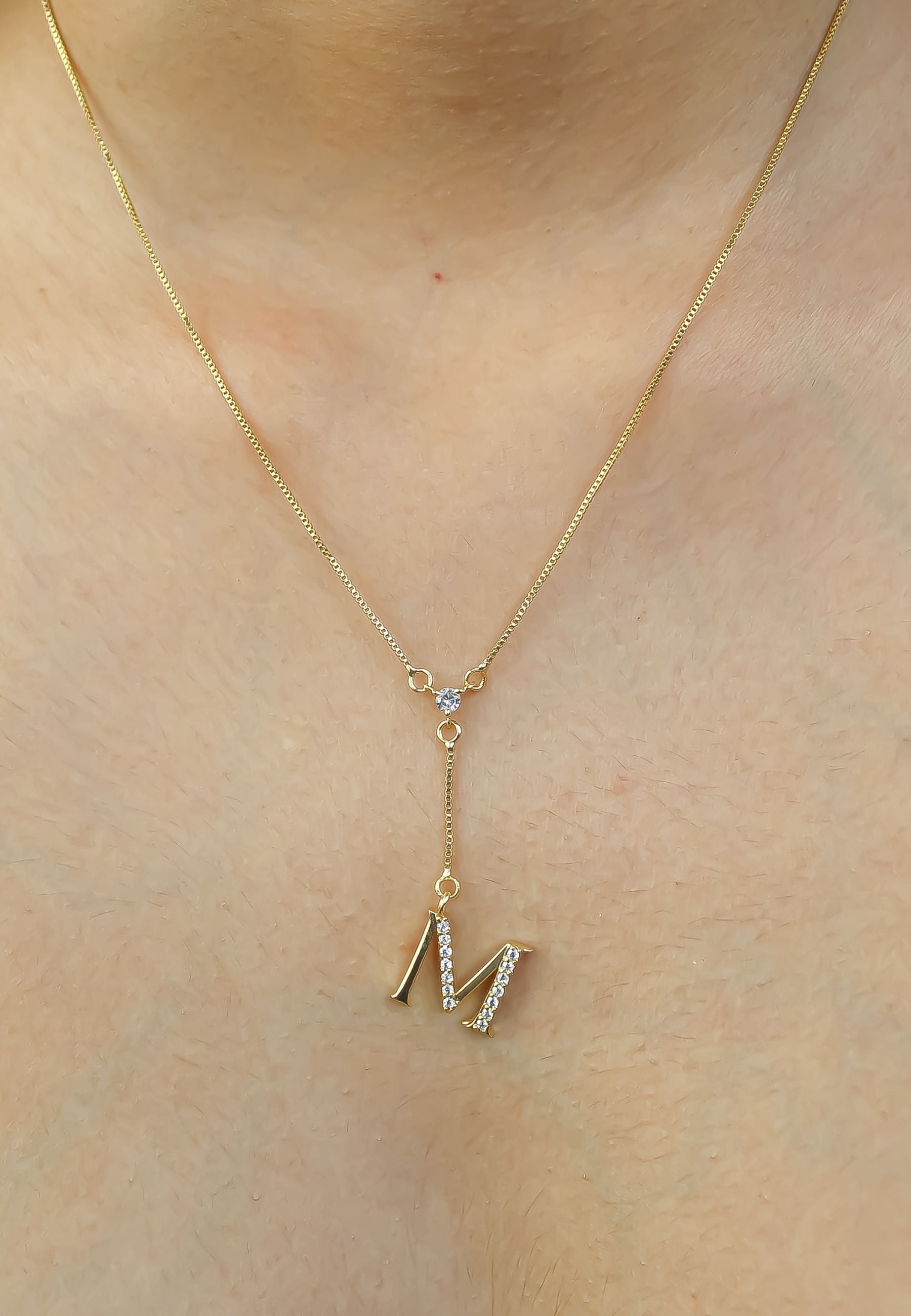 Elegant Golden Alphabet Necklace with zirconia stones, showcasing a personalized initial, perfect for layering or gifting.