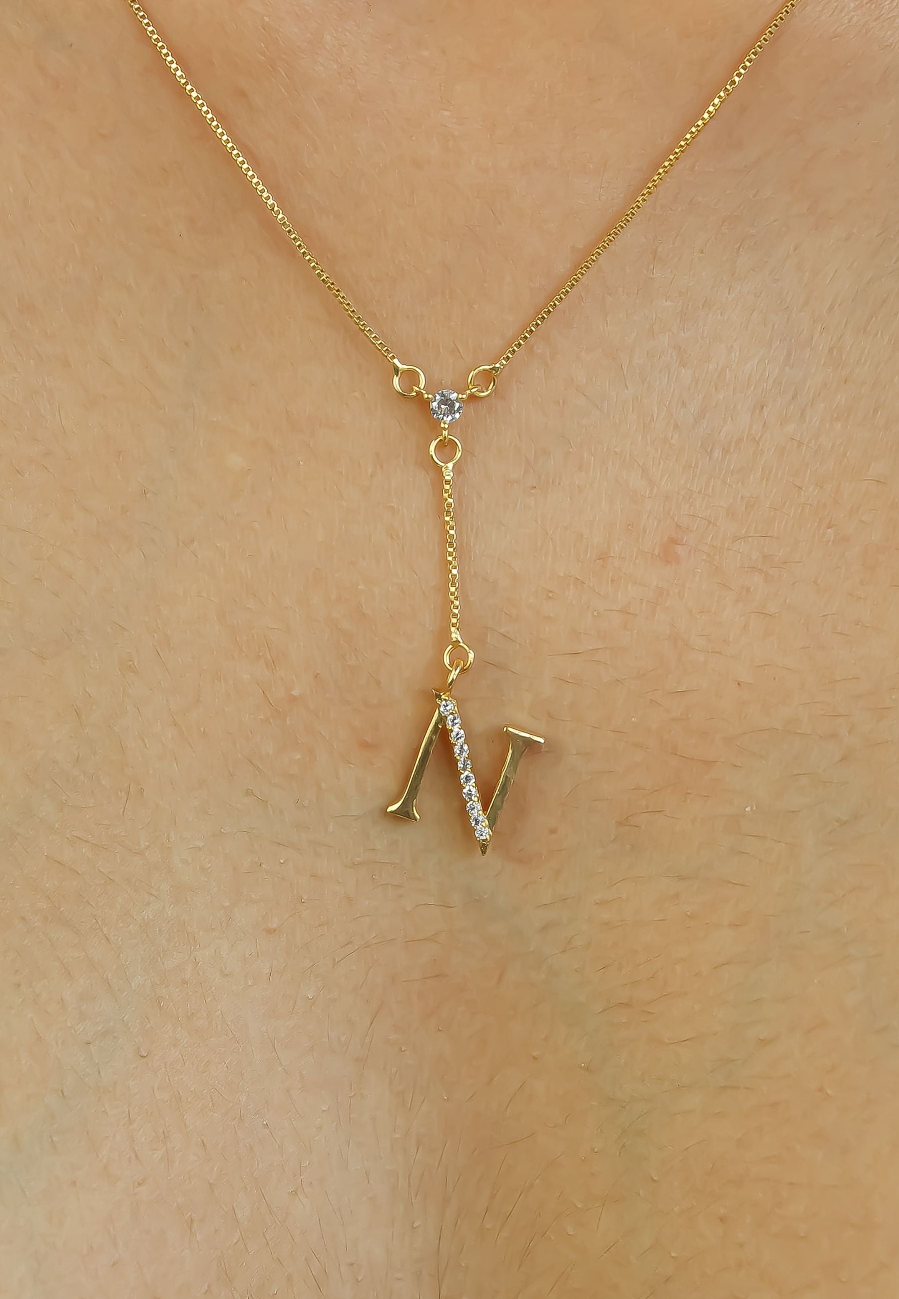 Elegant Golden Alphabet Necklace with zirconia stones, showcasing a personalized initial, perfect for layering or gifting.