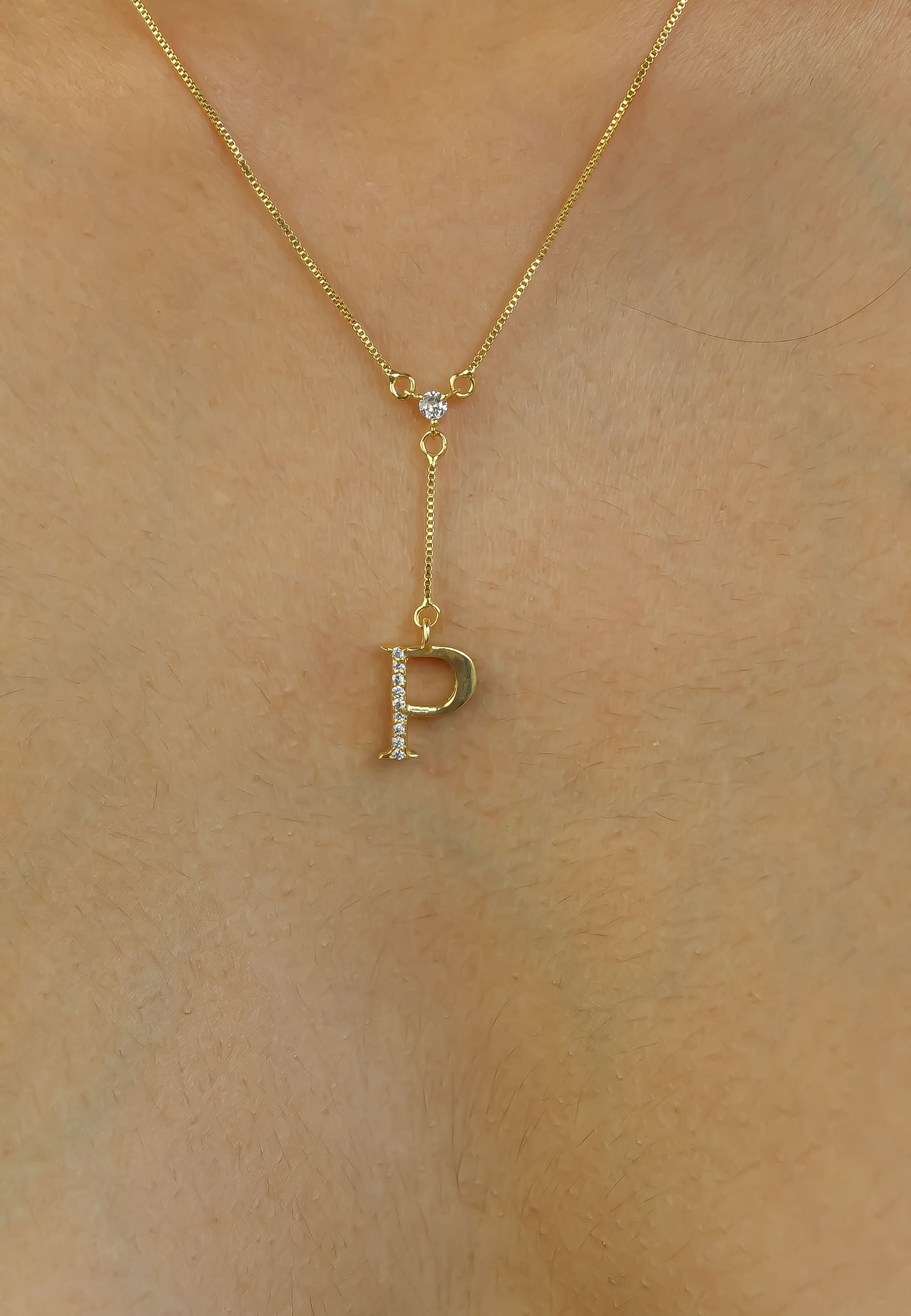 Elegant Golden Alphabet Necklace with zirconia stones, showcasing a personalized initial, perfect for layering or gifting.