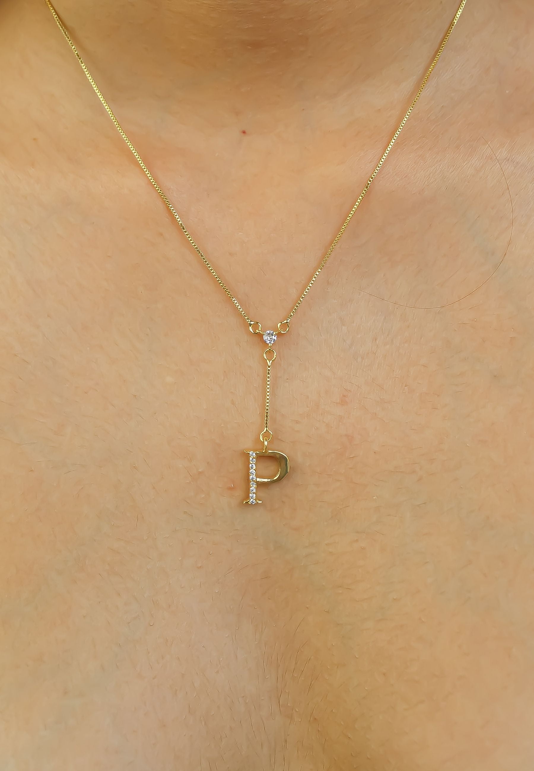 Elegant Golden Alphabet Necklace with zirconia stones, showcasing a personalized initial, perfect for layering or gifting.