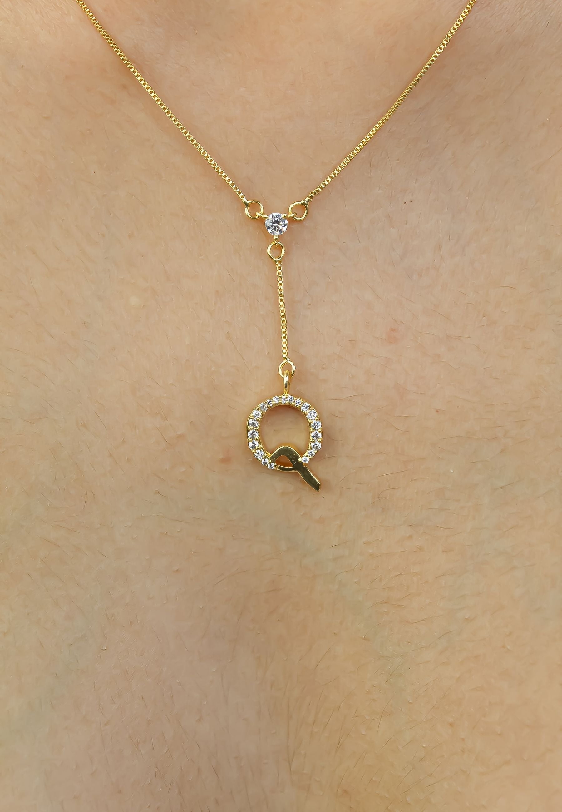 Elegant Golden Alphabet Necklace with zirconia stones, showcasing a personalized initial, perfect for layering or gifting.