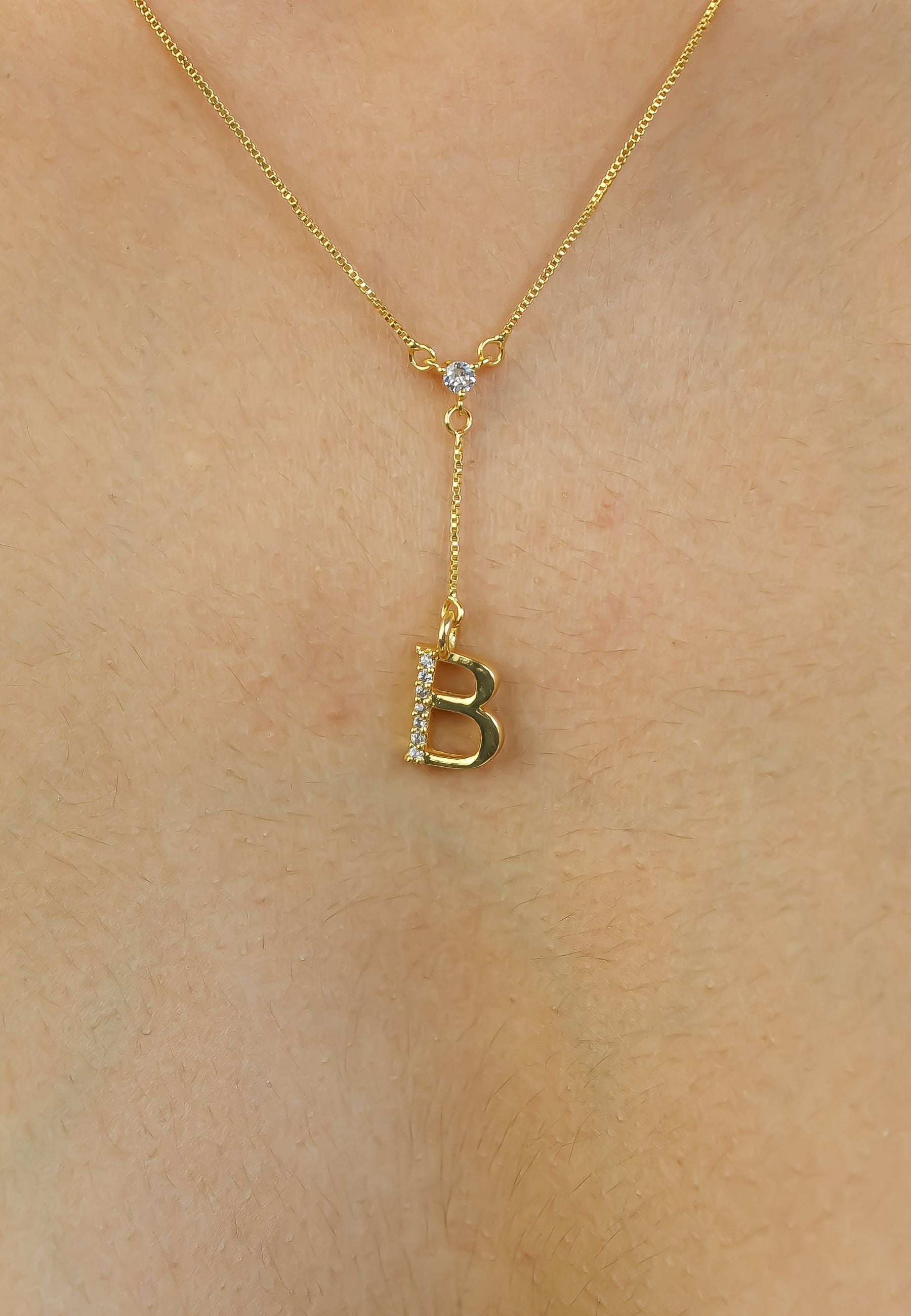 Elegant Golden Alphabet Necklace with zirconia stones, showcasing a personalized initial, perfect for layering or gifting.