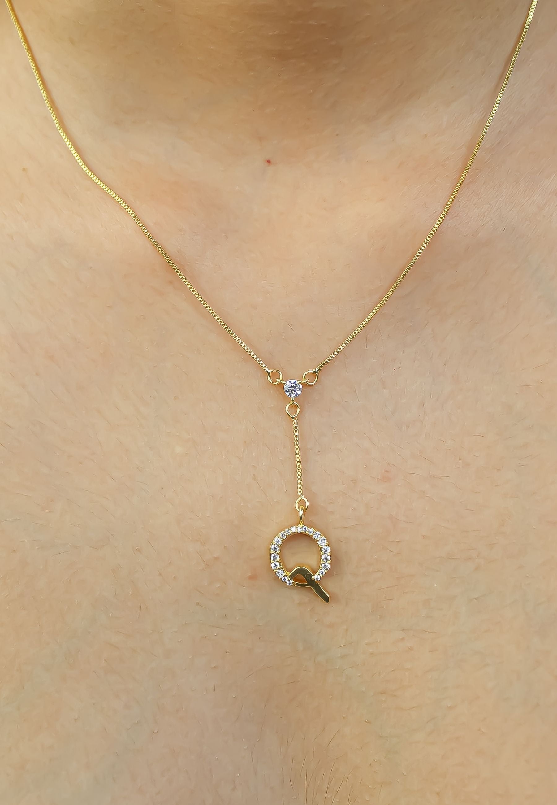 Elegant Golden Alphabet Necklace with zirconia stones, showcasing a personalized initial, perfect for layering or gifting.