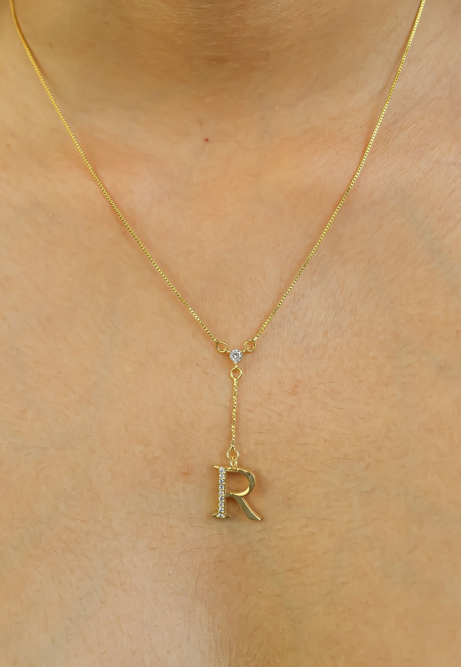 Elegant Golden Alphabet Necklace with zirconia stones, showcasing a personalized initial, perfect for layering or gifting.