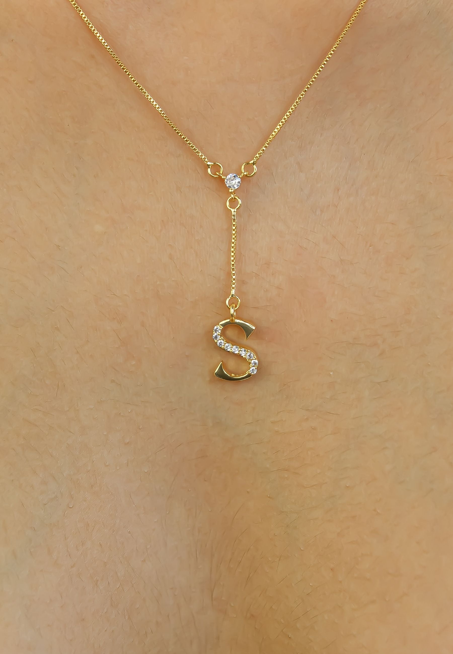 Elegant Golden Alphabet Necklace with zirconia stones, showcasing a personalized initial, perfect for layering or gifting.