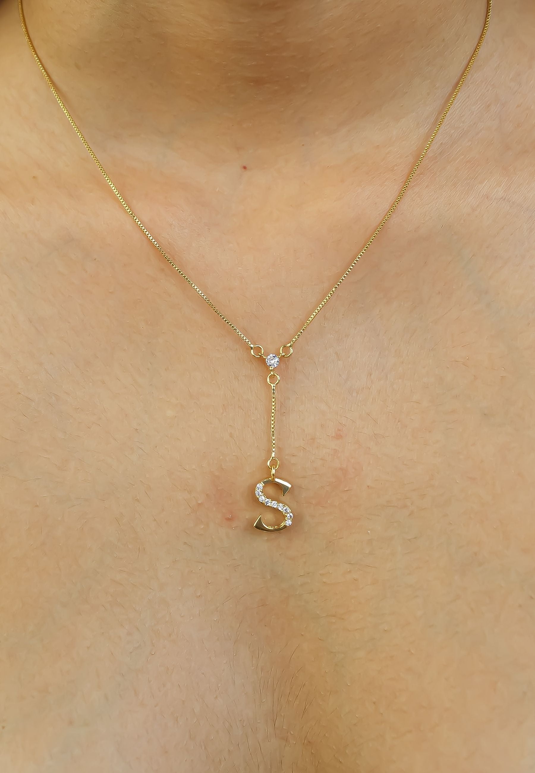 Elegant Golden Alphabet Necklace with zirconia stones, showcasing a personalized initial, perfect for layering or gifting.