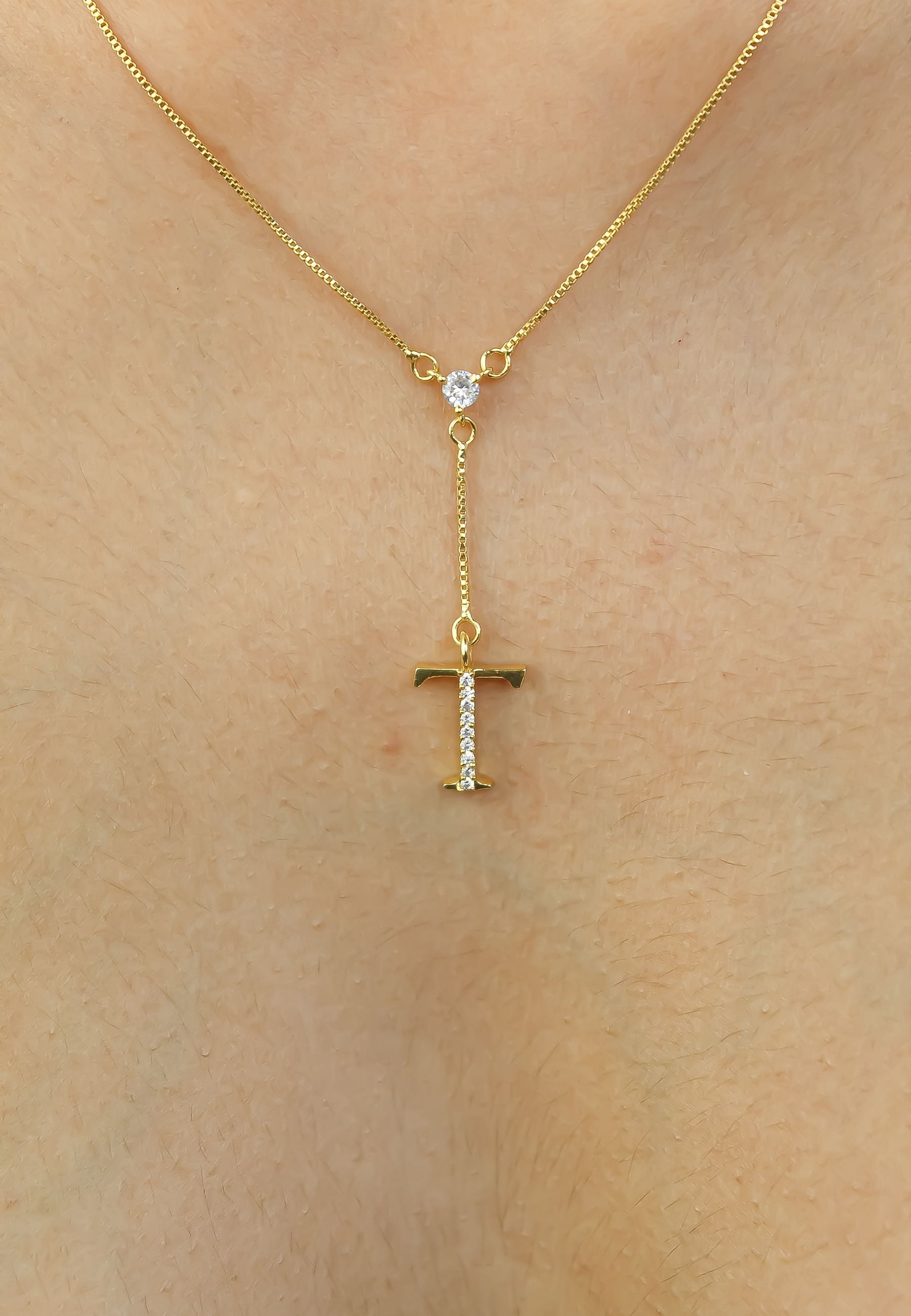 Elegant Golden Alphabet Necklace with zirconia stones, showcasing a personalized initial, perfect for layering or gifting.